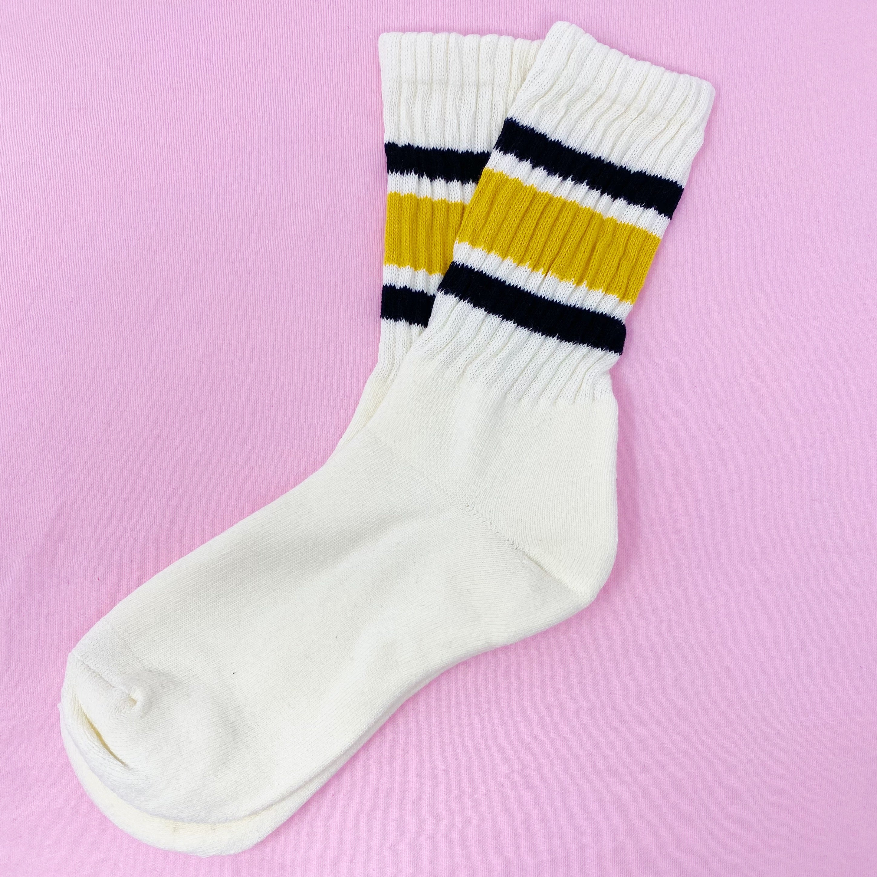 A pair of Classic Striped Socks featuring trendy stripes in vibrant colors, showcasing their comfortable cotton blend material.