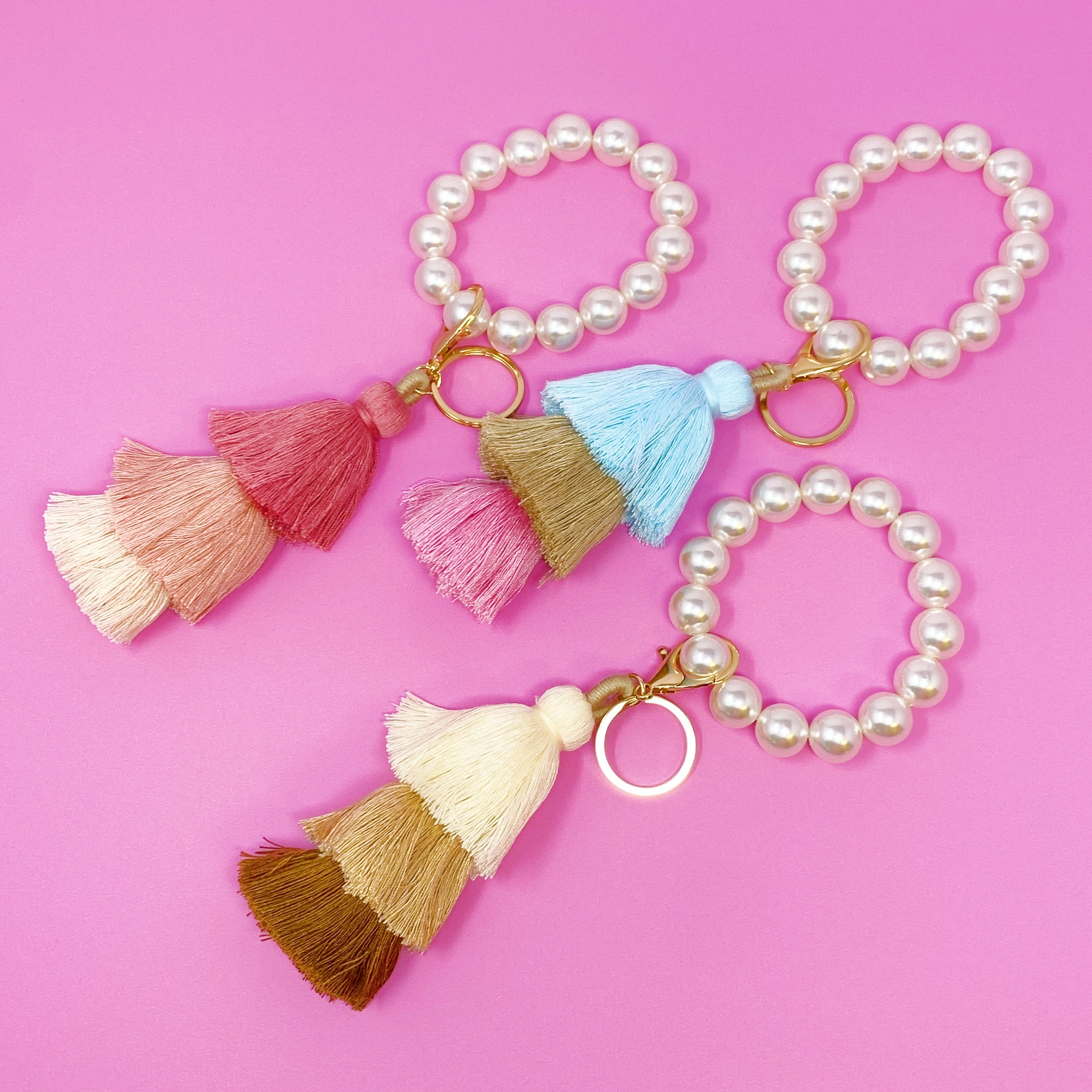 Classy Girl Pearl Tassel Key Chain featuring a large pearl bead handle and a chic 3-tier tassel drop with gold hardware.