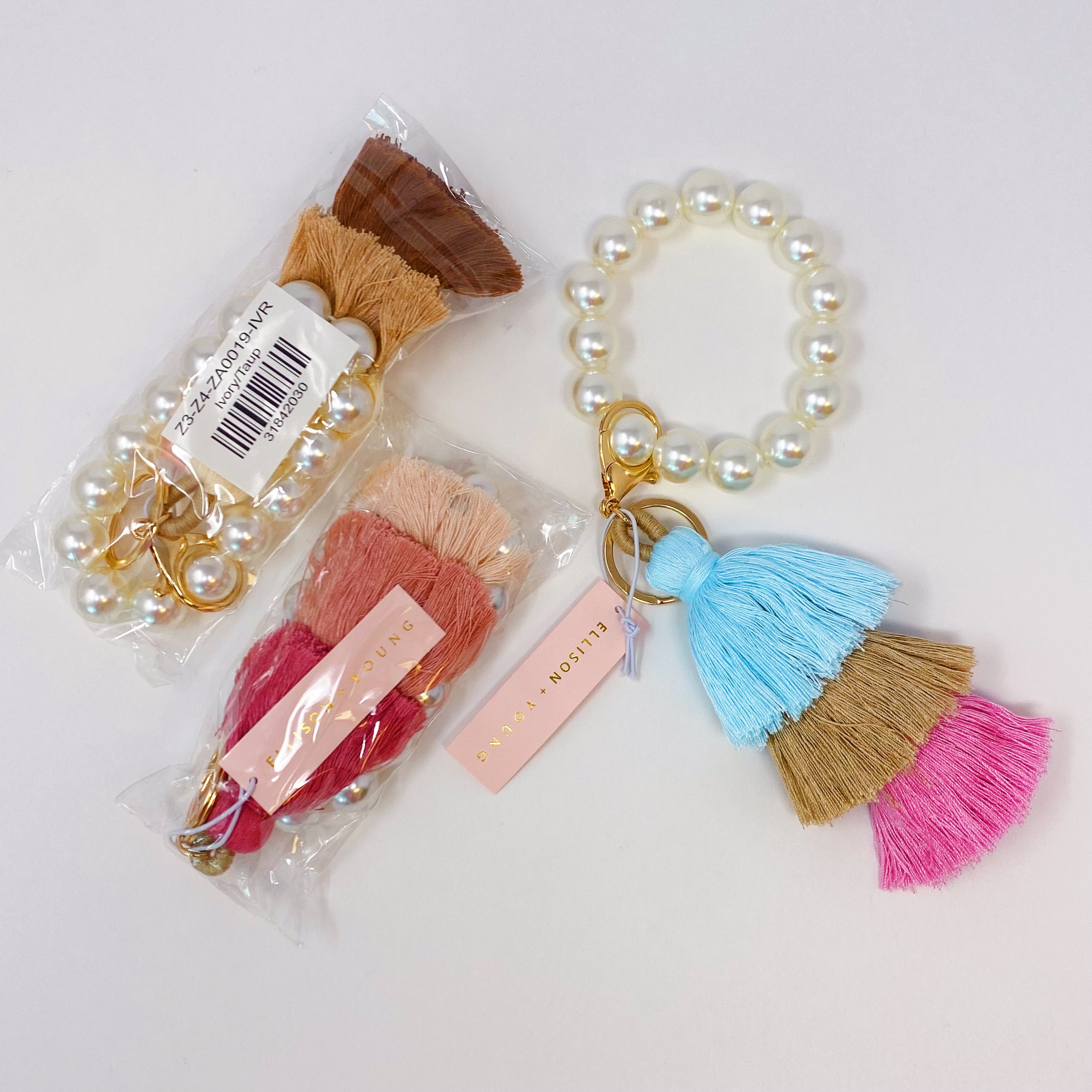 Classy Girl Pearl Tassel Key Chain featuring a large pearl bead handle and a chic 3-tier tassel drop with gold hardware.