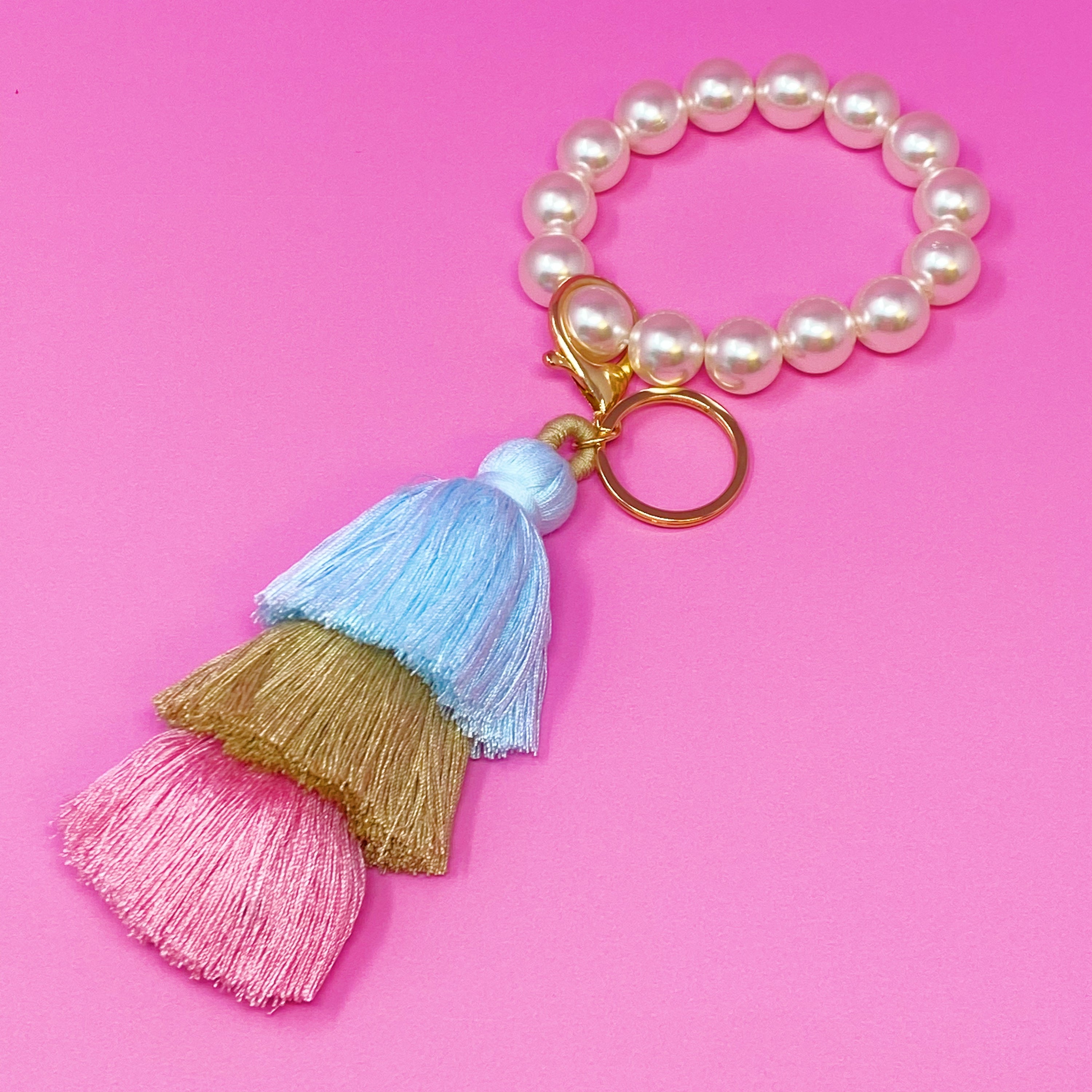 Classy Girl Pearl Tassel Key Chain featuring a large pearl bead handle and a chic 3-tier tassel drop with gold hardware.