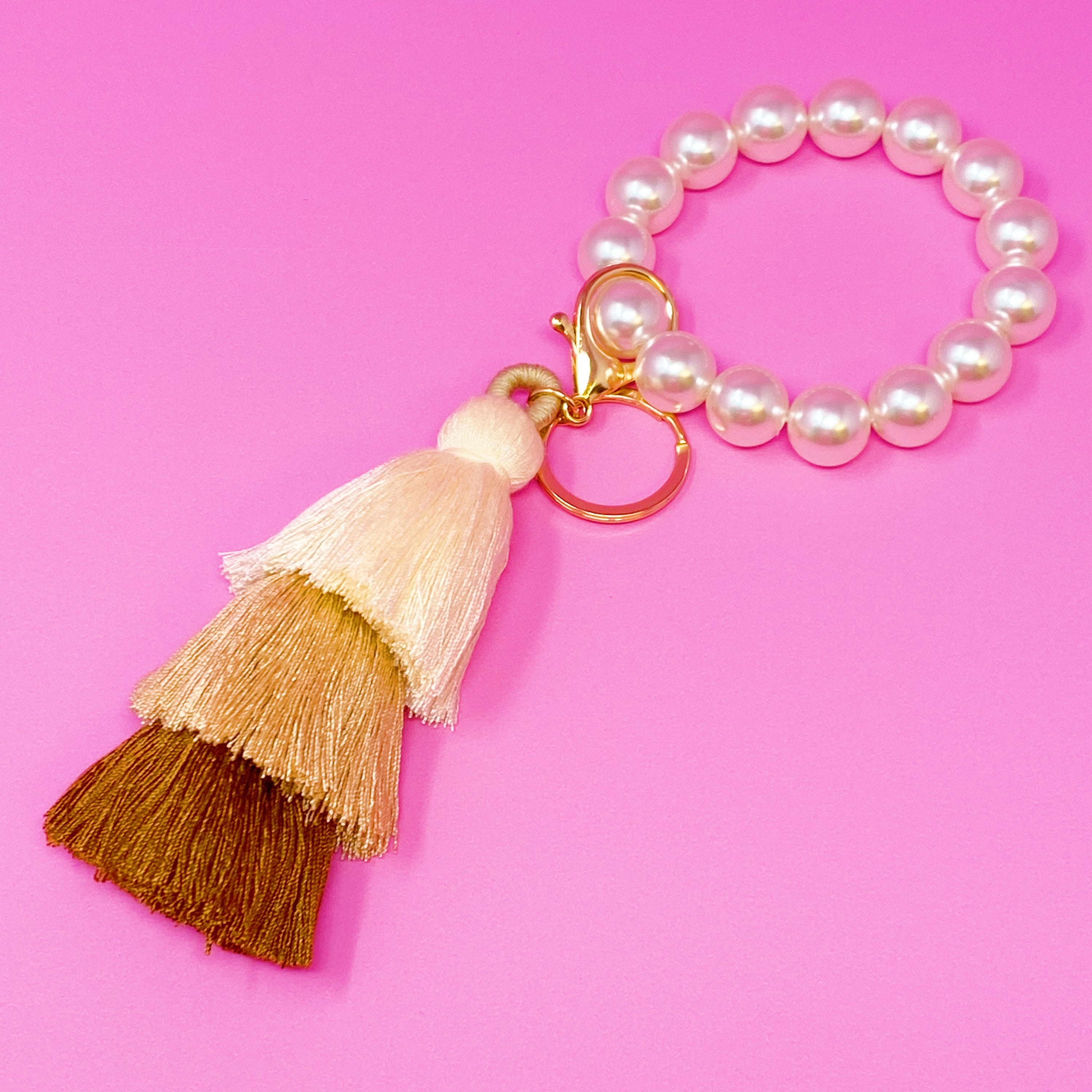 Classy Girl Pearl Tassel Key Chain featuring a large pearl bead handle and a chic 3-tier tassel drop with gold hardware.