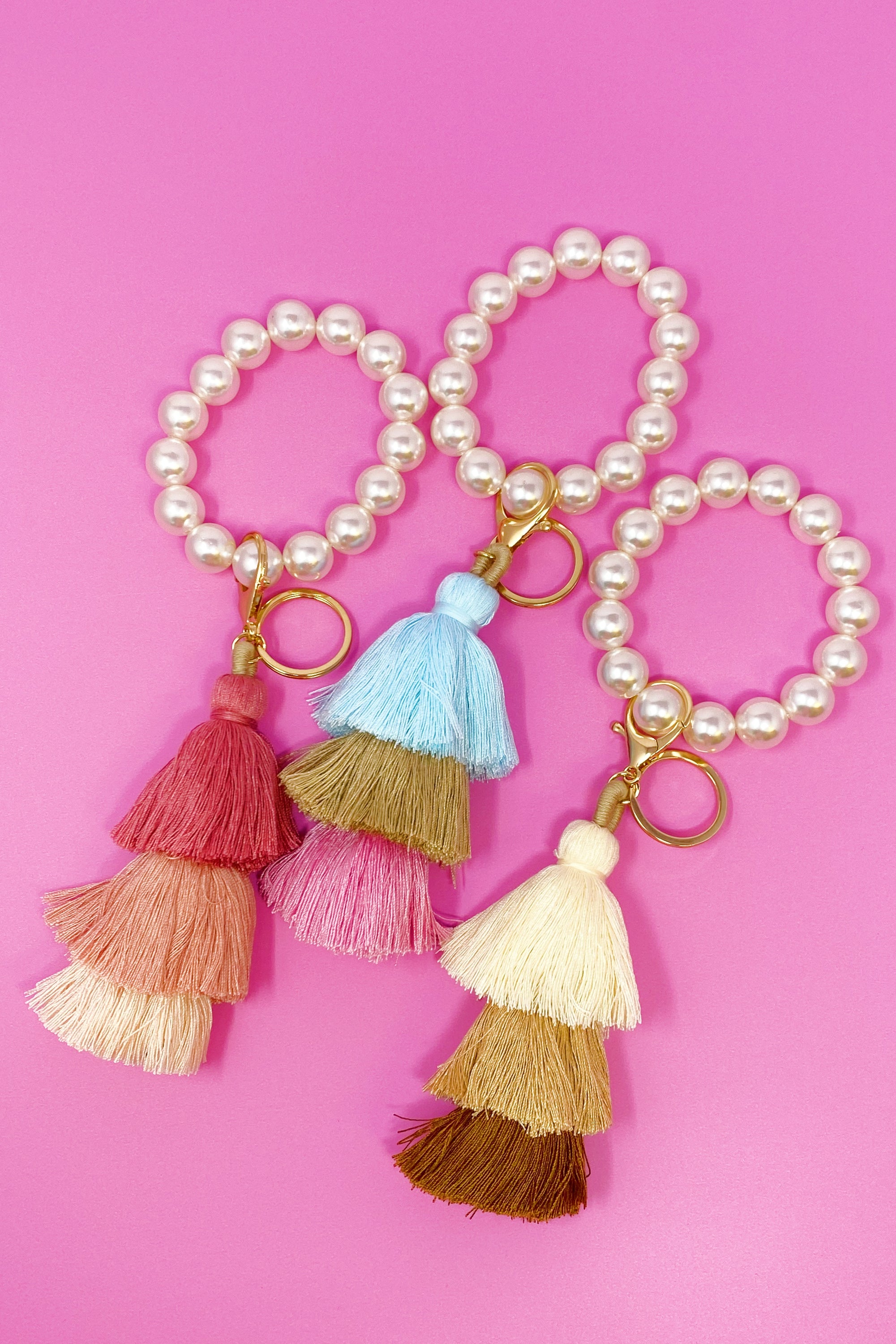 Classy Girl Pearl Tassel Key Chain featuring a large pearl bead handle and a chic 3-tier tassel drop with gold hardware.