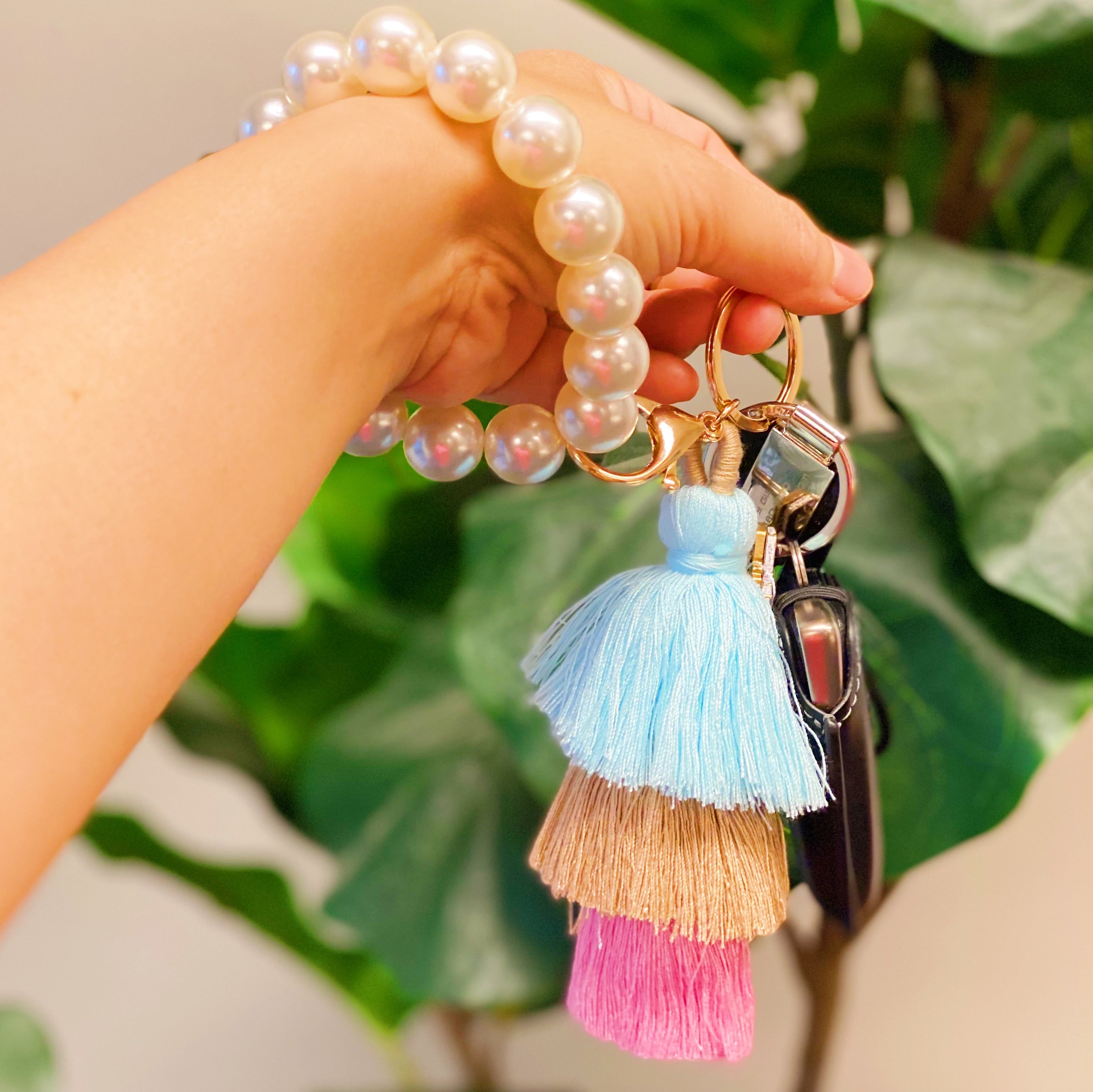 Classy Girl Pearl Tassel Key Chain featuring a large pearl bead handle and a chic 3-tier tassel drop with gold hardware.