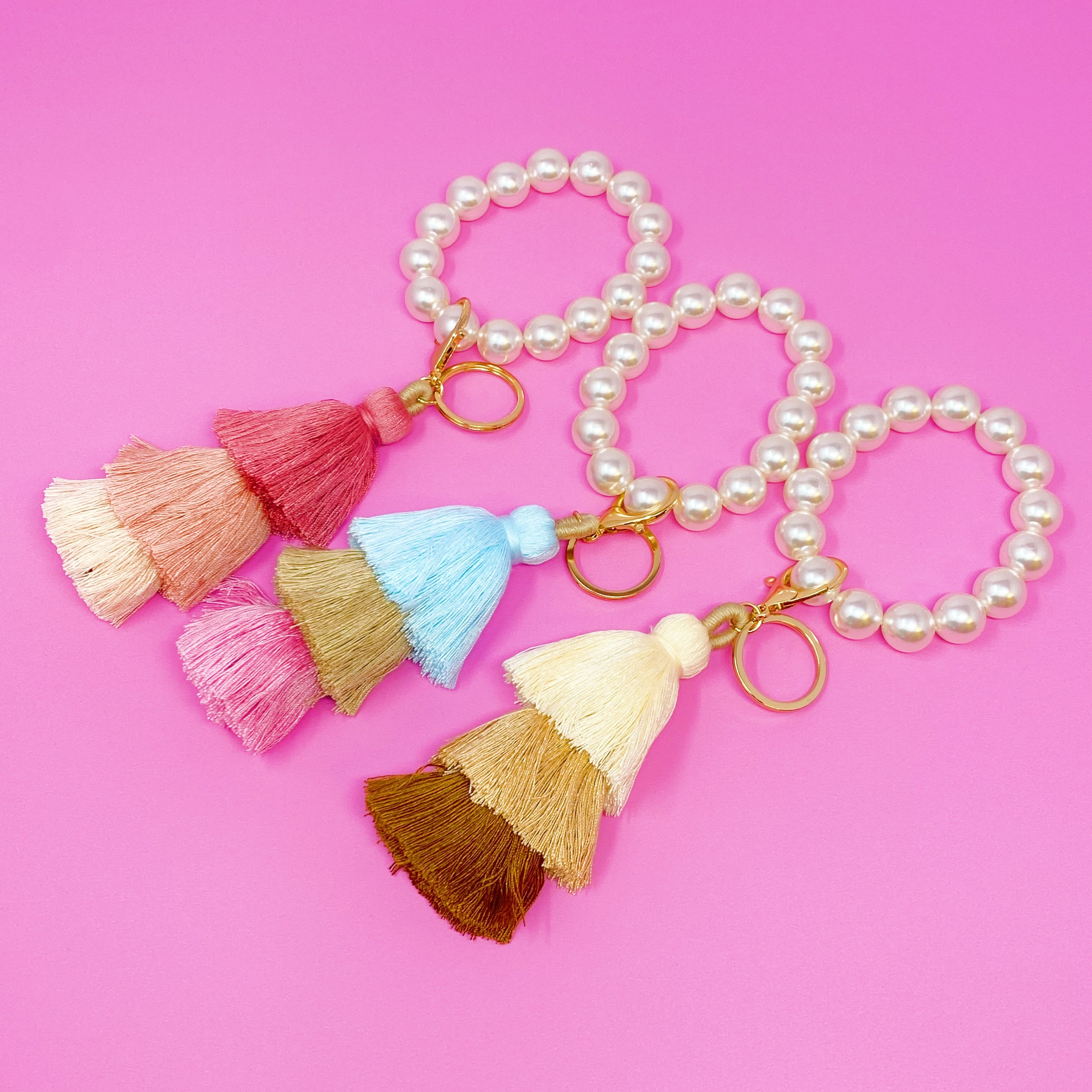 Classy Girl Pearl Tassel Key Chain featuring a large pearl bead handle and a chic 3-tier tassel drop with gold hardware.