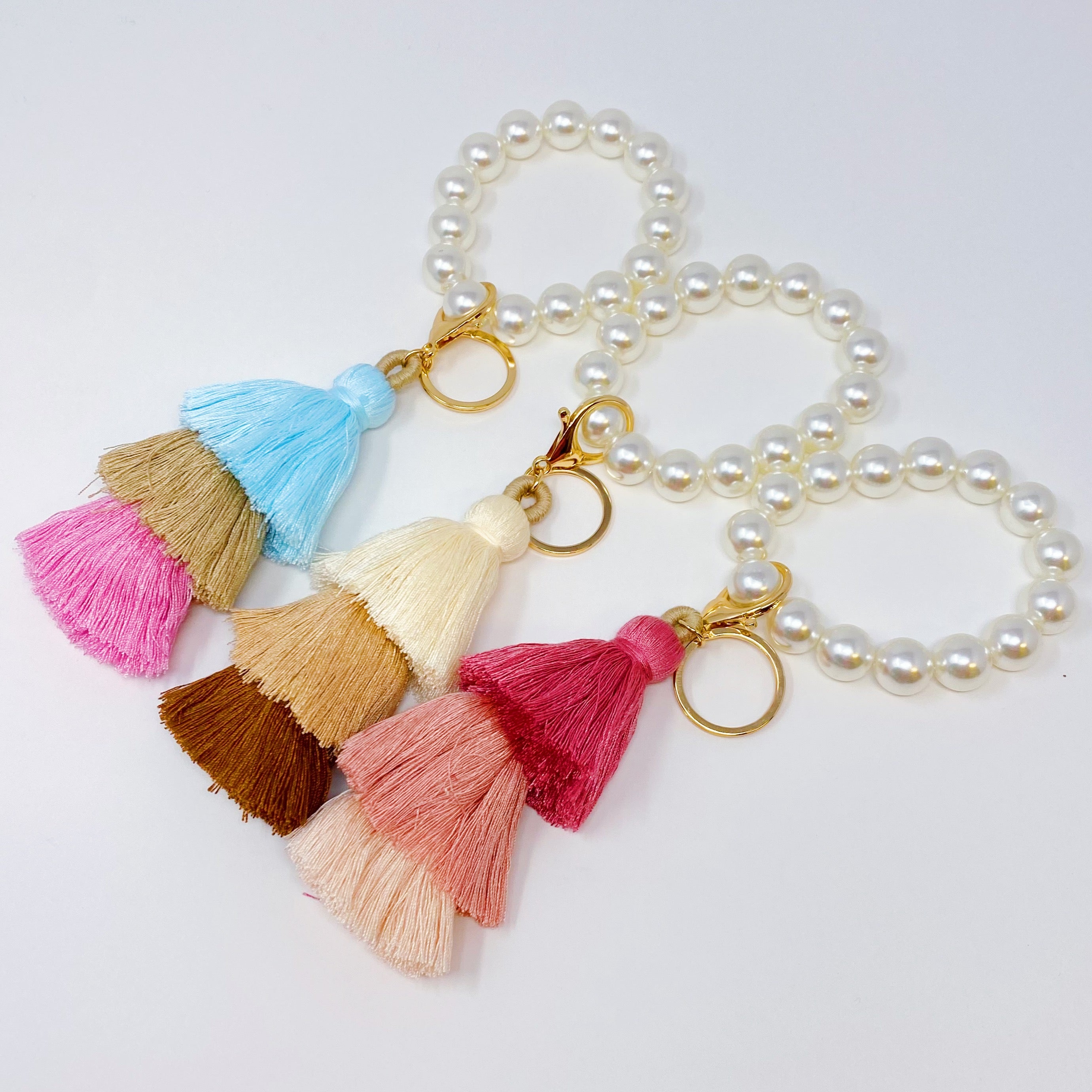 Classy Girl Pearl Tassel Key Chain featuring a large pearl bead handle and a chic 3-tier tassel drop with gold hardware.