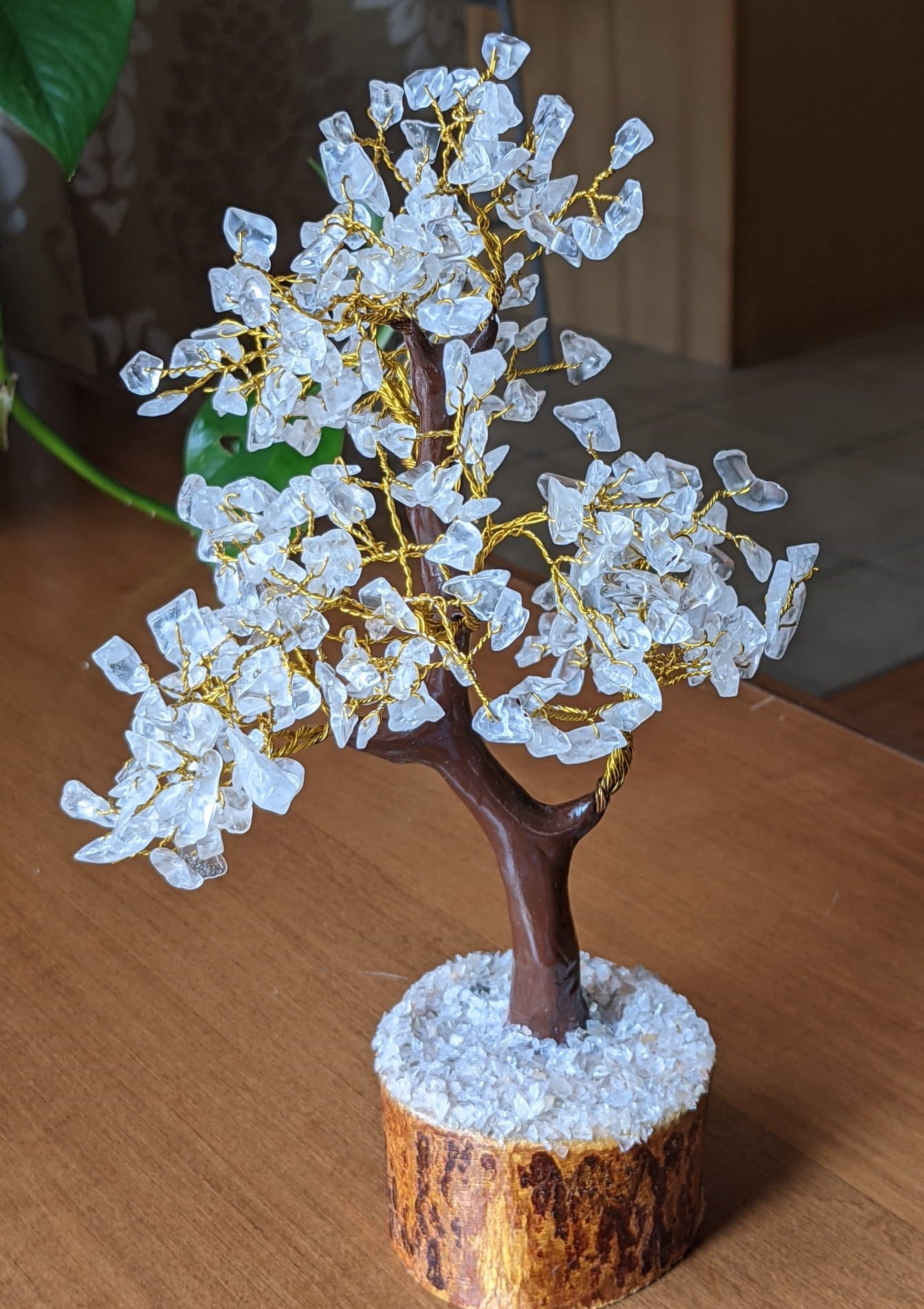 A beautifully handcrafted Clear Quartz Gemstone Tree featuring 300 natural quartz chips on a sturdy wooden base, standing 8-9 inches tall.