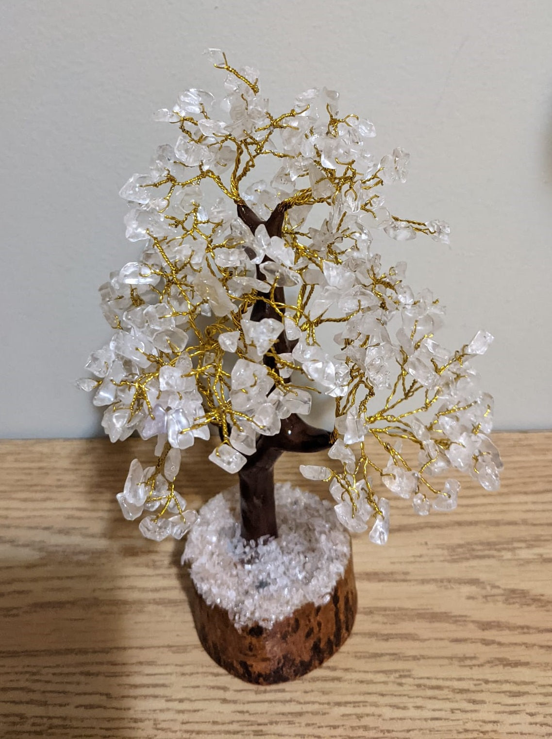 A beautifully handcrafted Clear Quartz Gemstone Tree featuring 300 natural quartz chips on a sturdy wooden base, standing 8-9 inches tall.