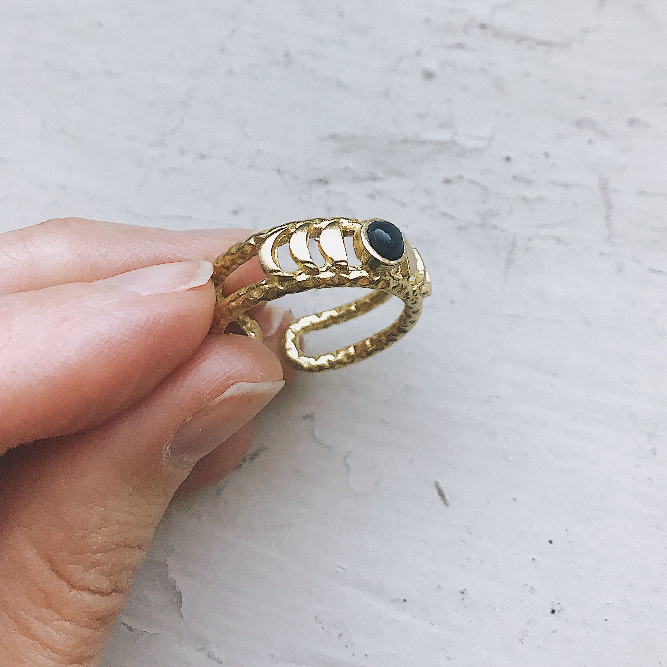 CLEARANCE Moon Phase Ring featuring a stunning black opal set in a gold or silver tone bezel, symbolizing strength and clarity.