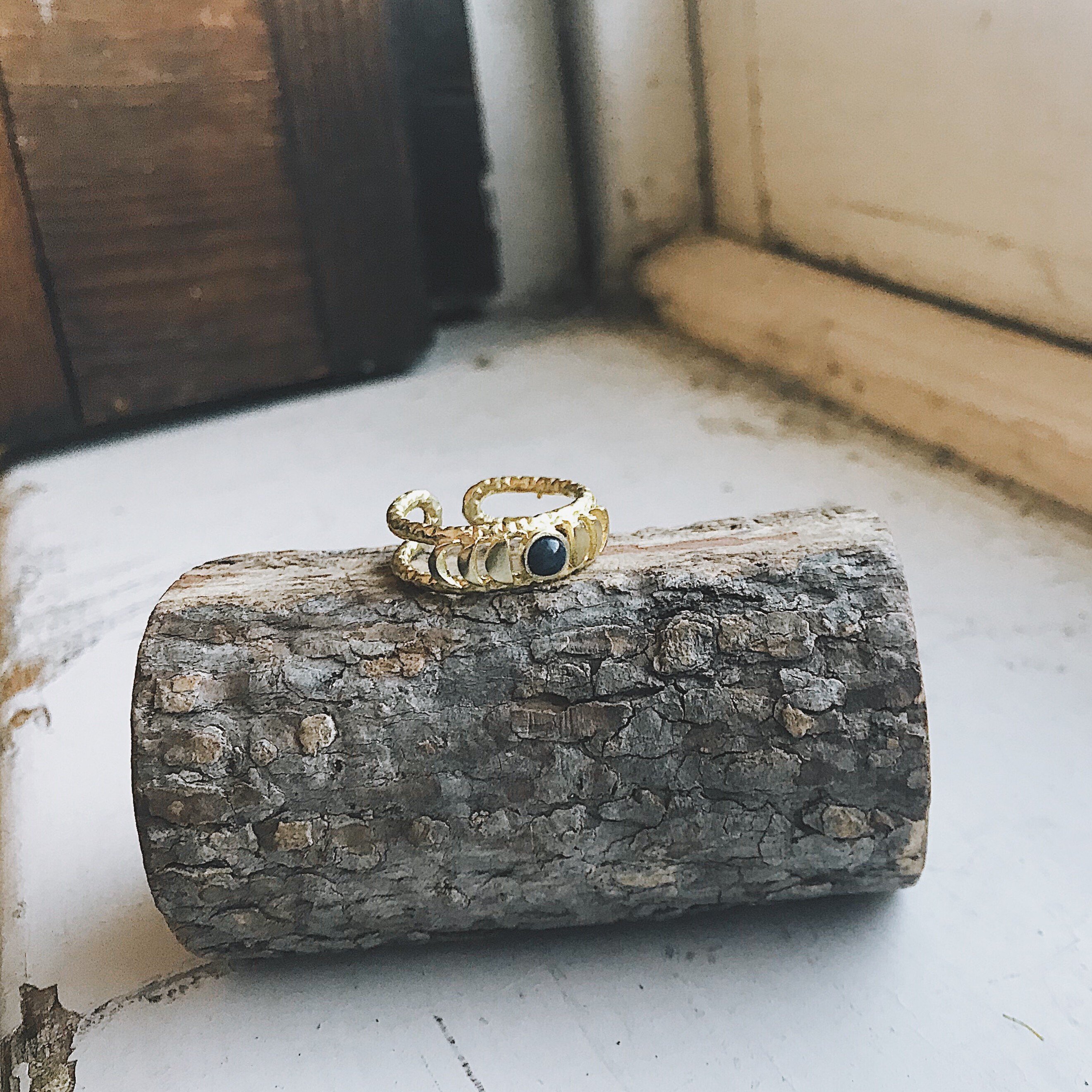 CLEARANCE Moon Phase Ring featuring a stunning black opal set in a gold or silver tone bezel, symbolizing strength and clarity.