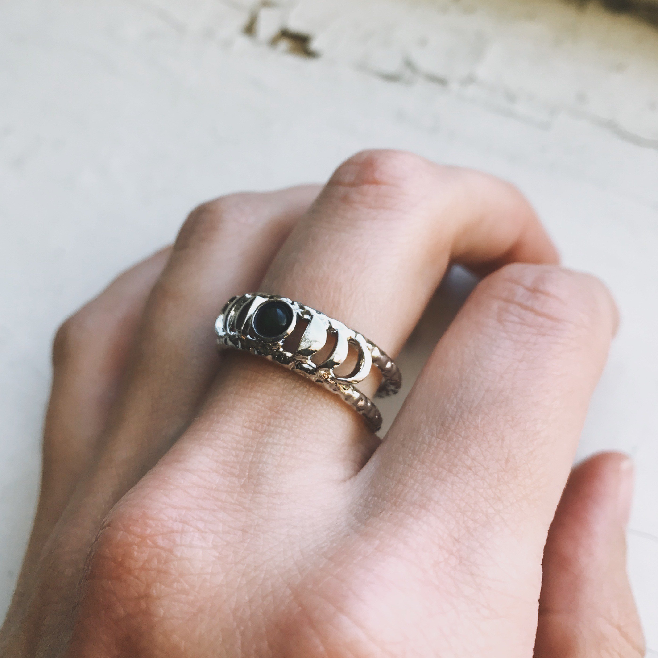 CLEARANCE Moon Phase Ring featuring a stunning black opal set in a gold or silver tone bezel, symbolizing strength and clarity.