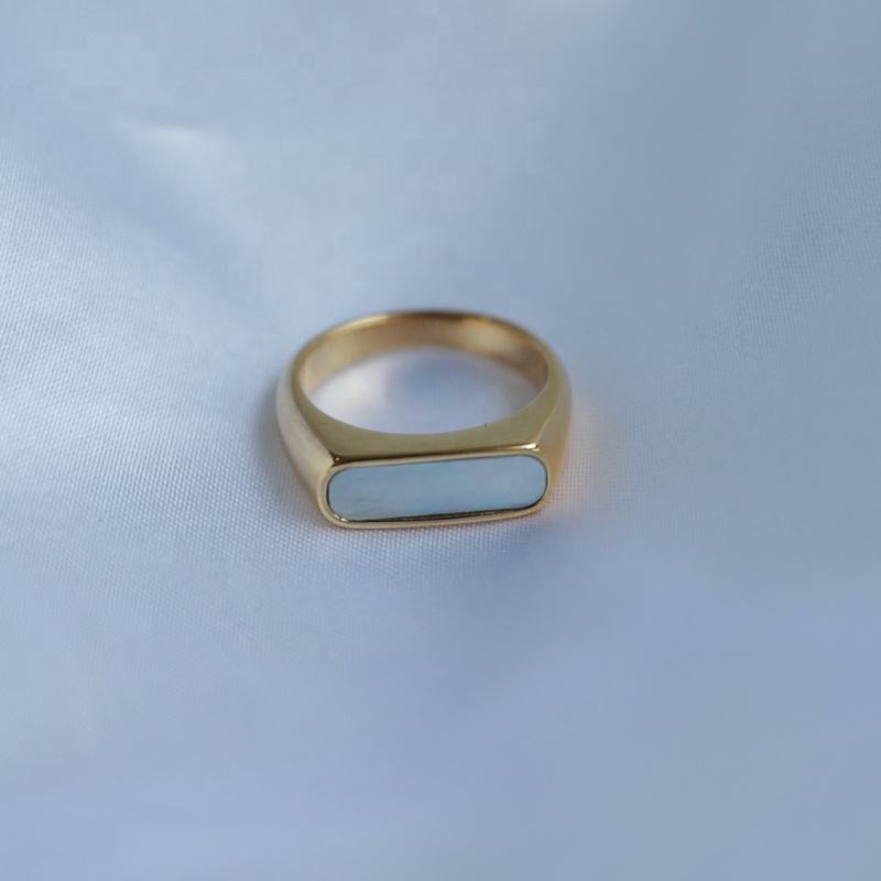 Clementine Thin Signet Shell Ring featuring 18k gold plated stainless steel and natural white shell stone, showcasing a minimalist geometric design.