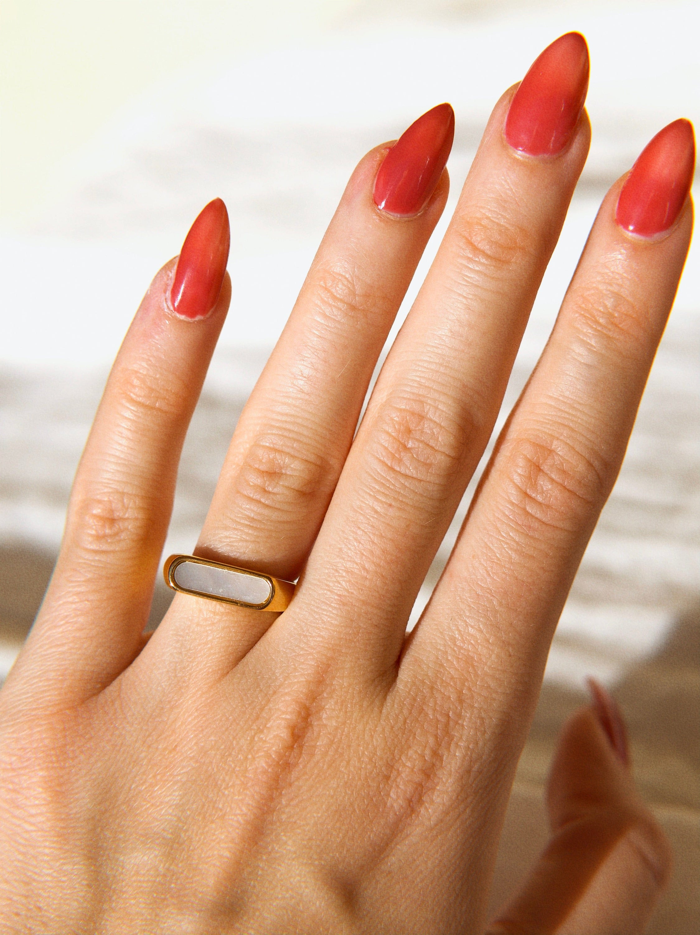 Clementine Thin Signet Shell Ring featuring 18k gold plated stainless steel and natural white shell stone, showcasing a minimalist geometric design.