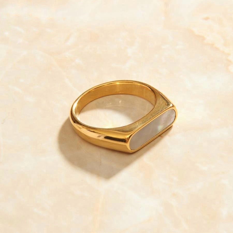 Clementine Thin Signet Shell Ring featuring 18k gold plated stainless steel and natural white shell stone, showcasing a minimalist geometric design.