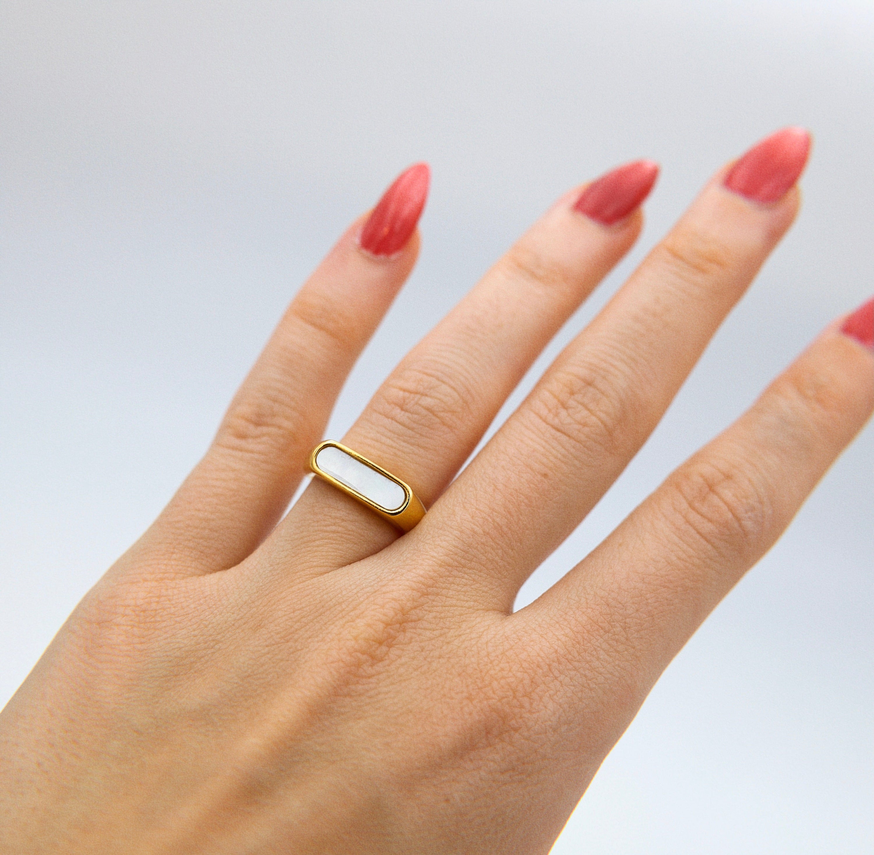 Clementine Thin Signet Shell Ring featuring 18k gold plated stainless steel and natural white shell stone, showcasing a minimalist geometric design.