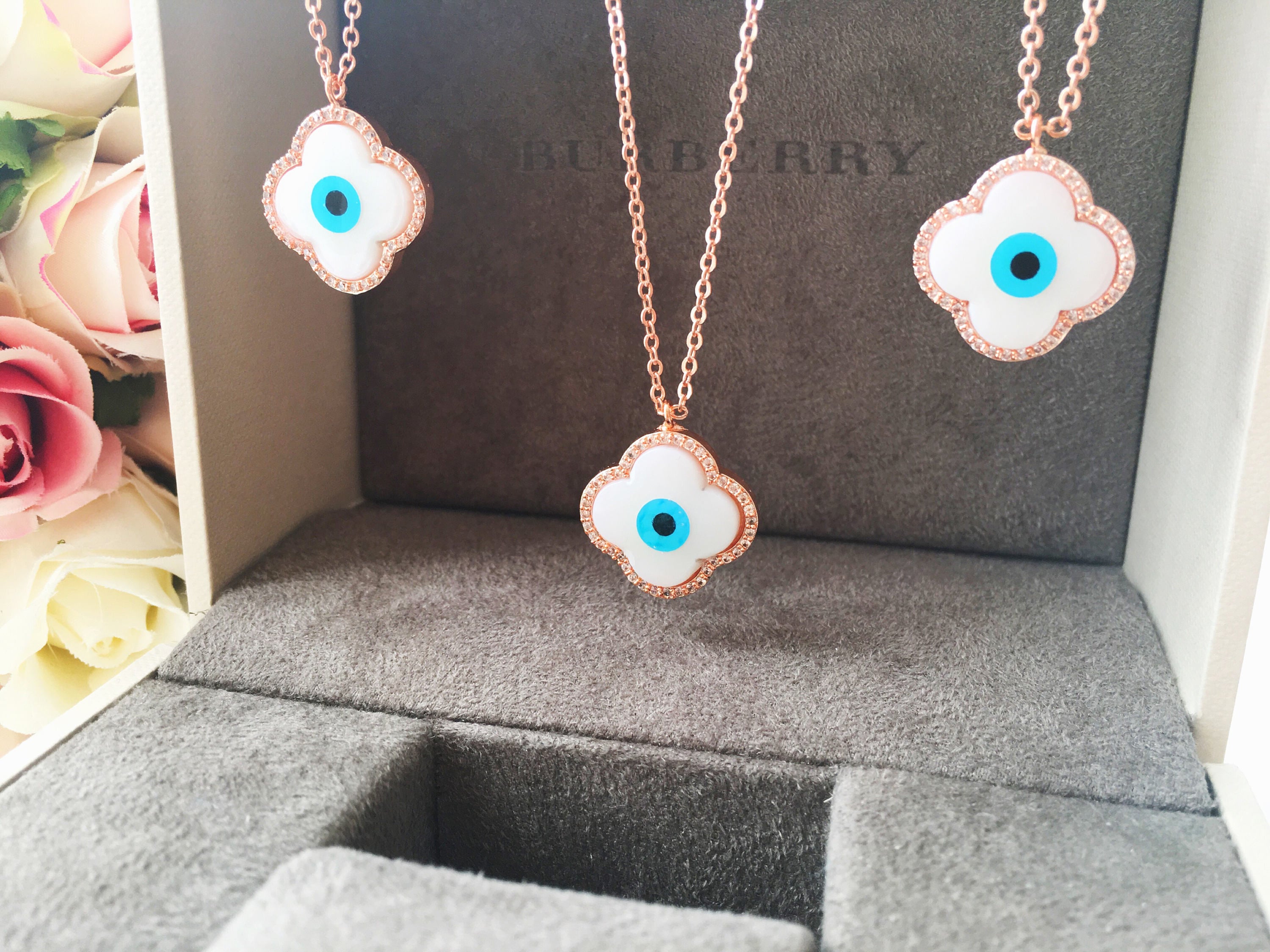 Handmade Clover Evil Eye Necklace featuring a mother of pearl charm and rose gold plating, adjustable chain length.