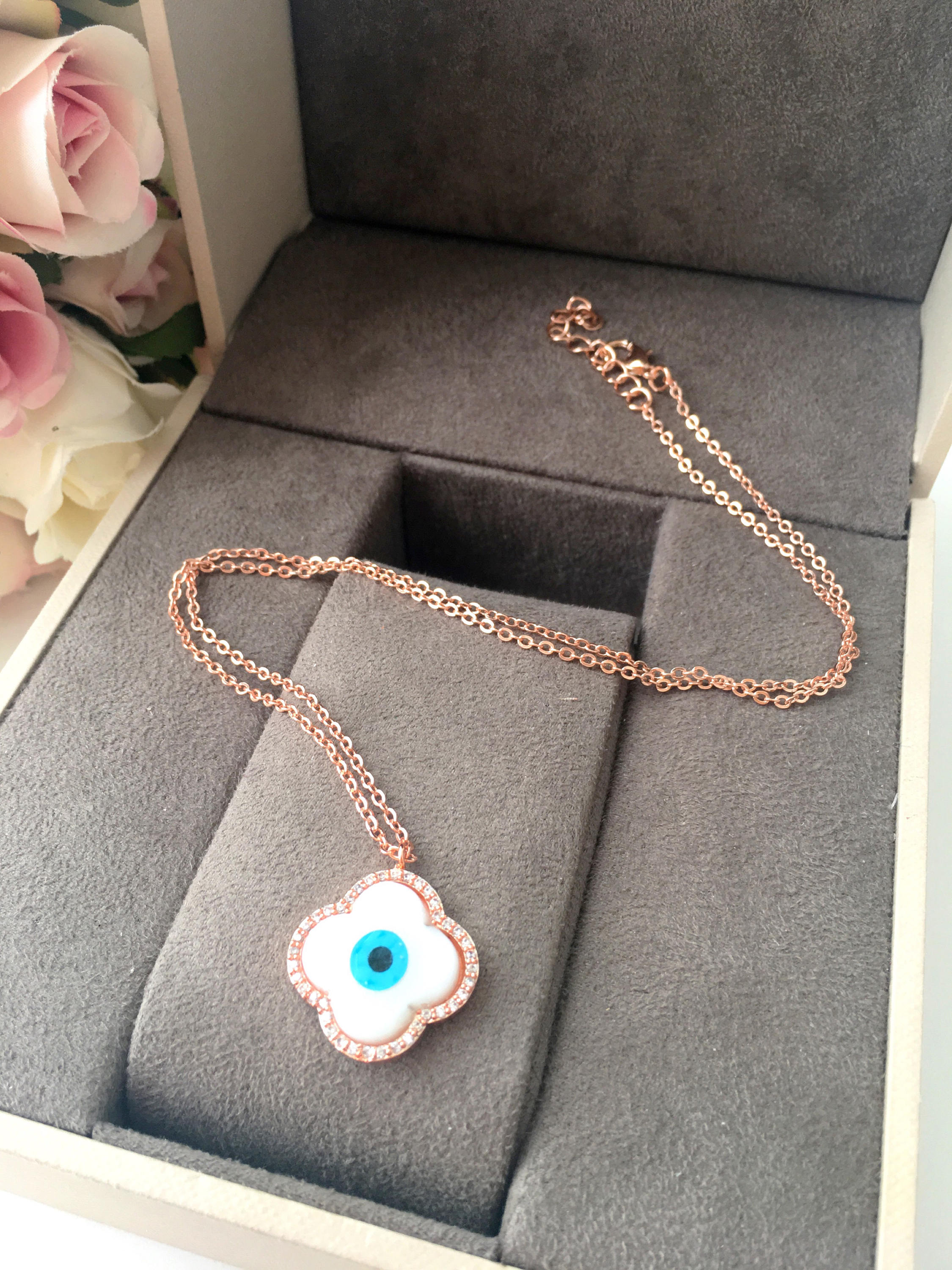 Handmade Clover Evil Eye Necklace featuring a mother of pearl charm and rose gold plating, adjustable chain length.