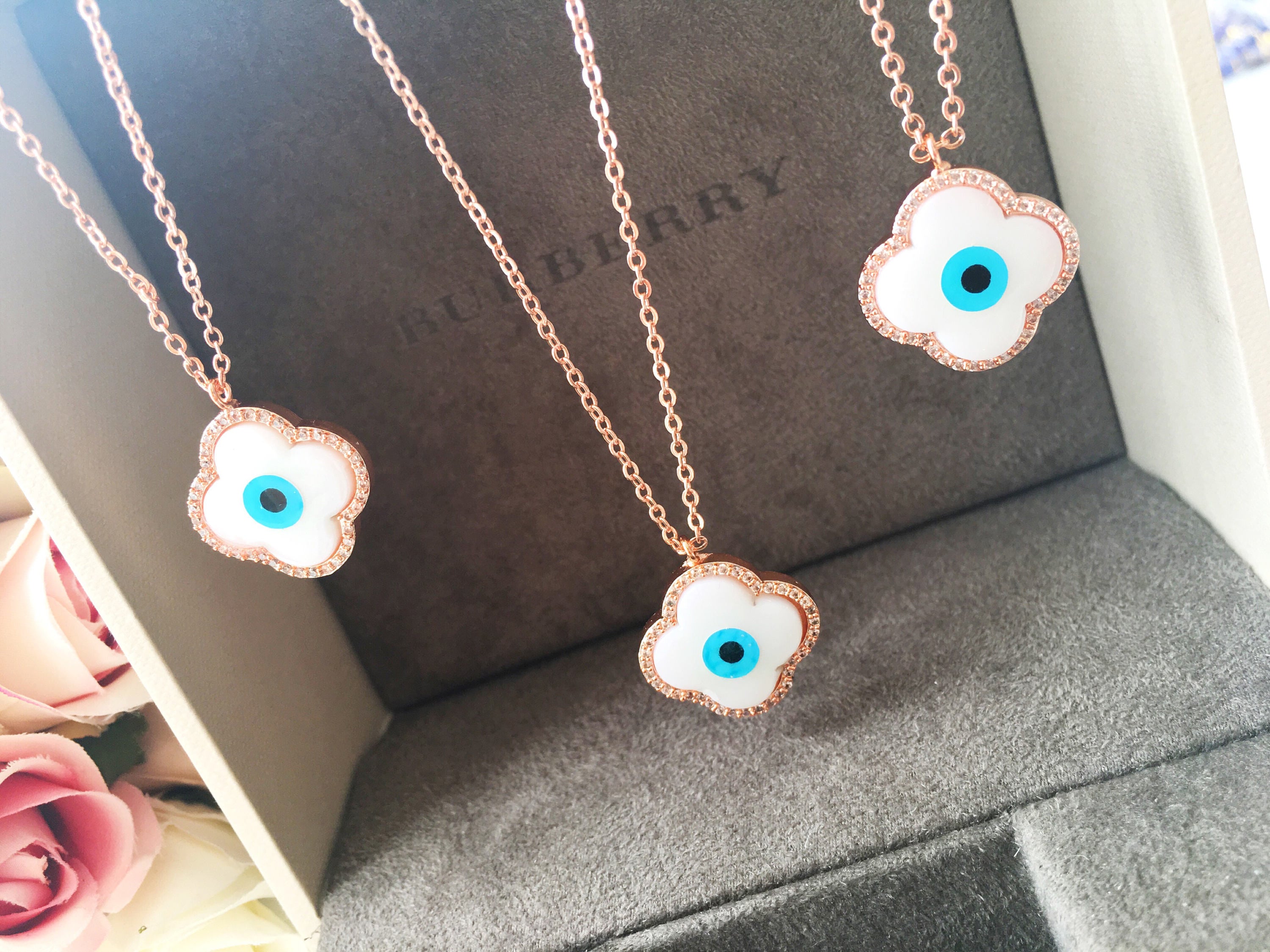 Handmade Clover Evil Eye Necklace featuring a mother of pearl charm and rose gold plating, adjustable chain length.