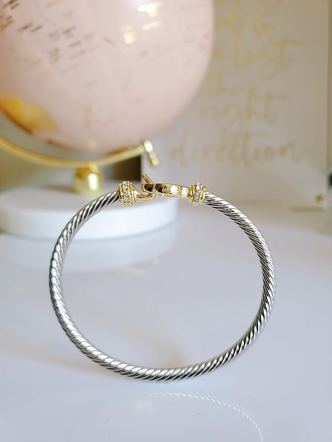 Elegant Clover Hook Bangle Bracelet made of stainless steel with sterling silver and 18K gold plating, featuring a unique clover hook design.