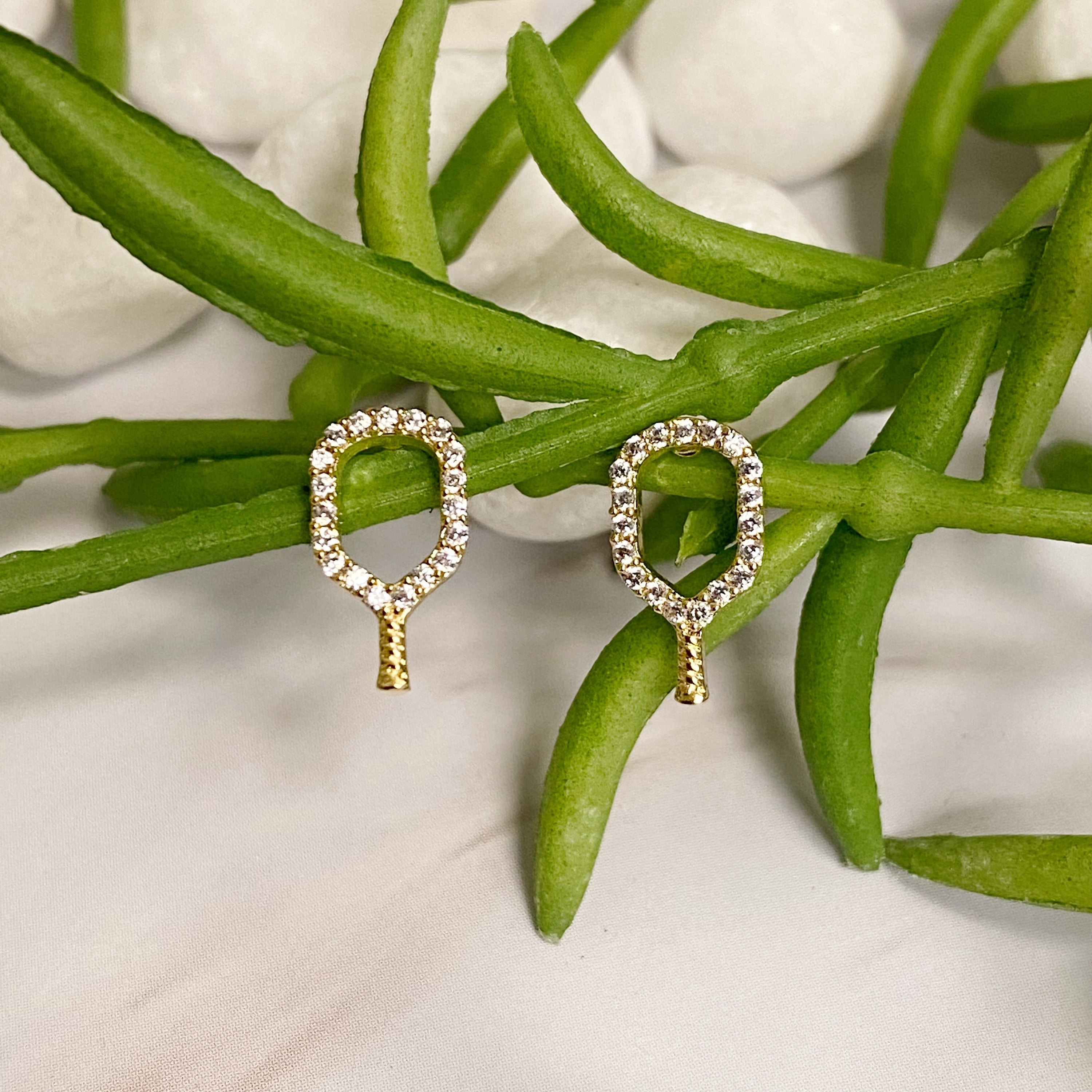 A pair of elegant gold plated brass earrings shaped like pickleball rackets, perfect for fans of the sport.