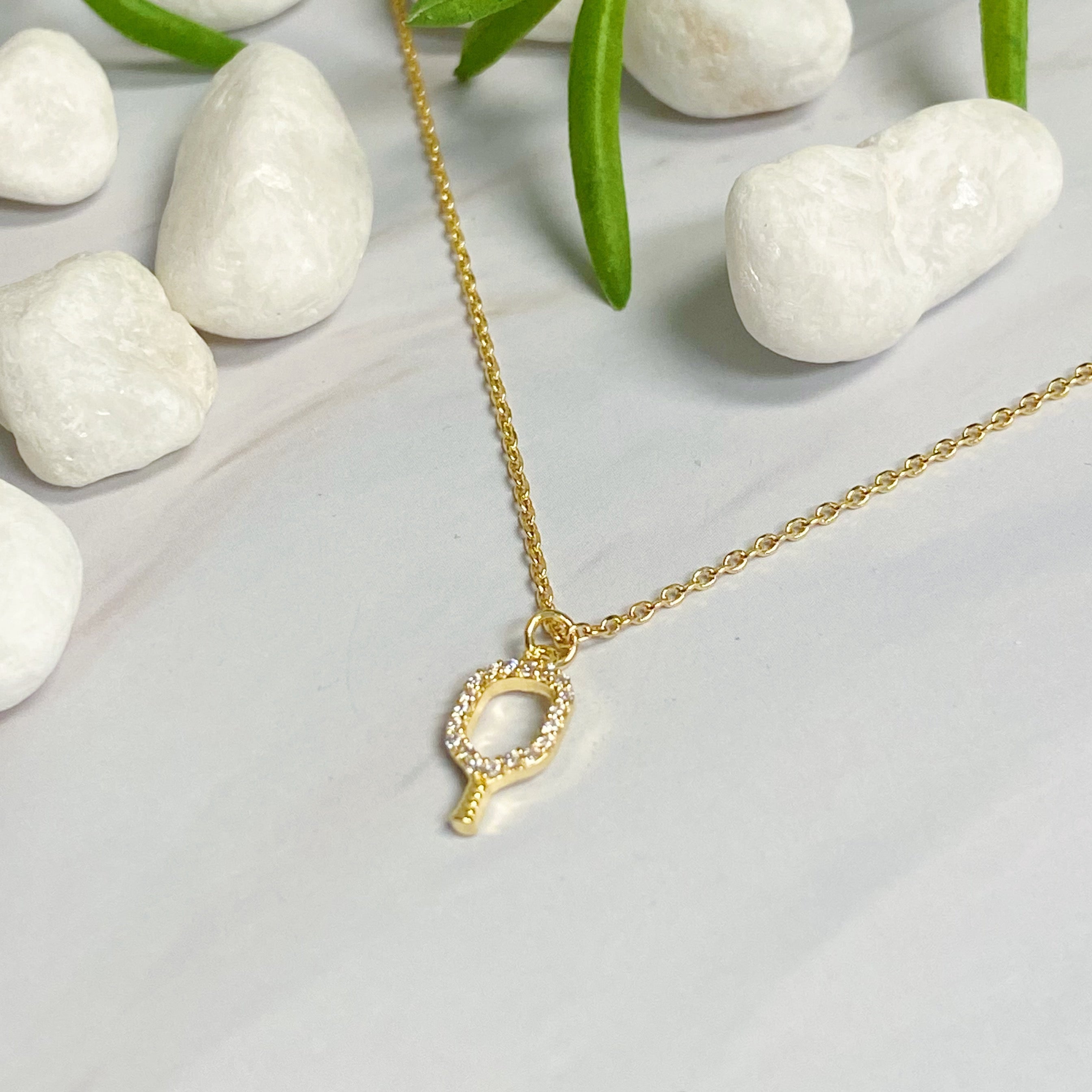 A delicate gold plated brass necklace featuring a pickleball racket outline, perfect for pickleball enthusiasts.