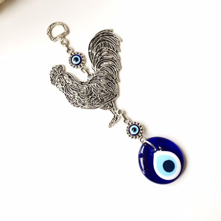 Handmade Cock Evil Eye Wall Hanging featuring a vibrant evil eye bead and metal charm, measuring 20cm in length.