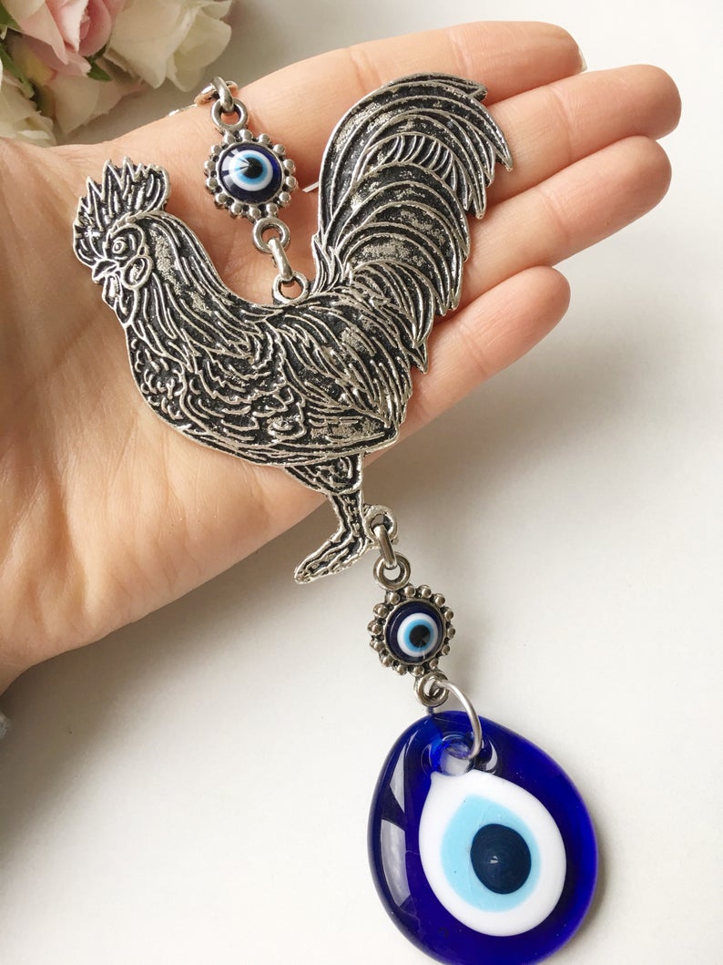 Handmade Cock Evil Eye Wall Hanging featuring a vibrant evil eye bead and metal charm, measuring 20cm in length.