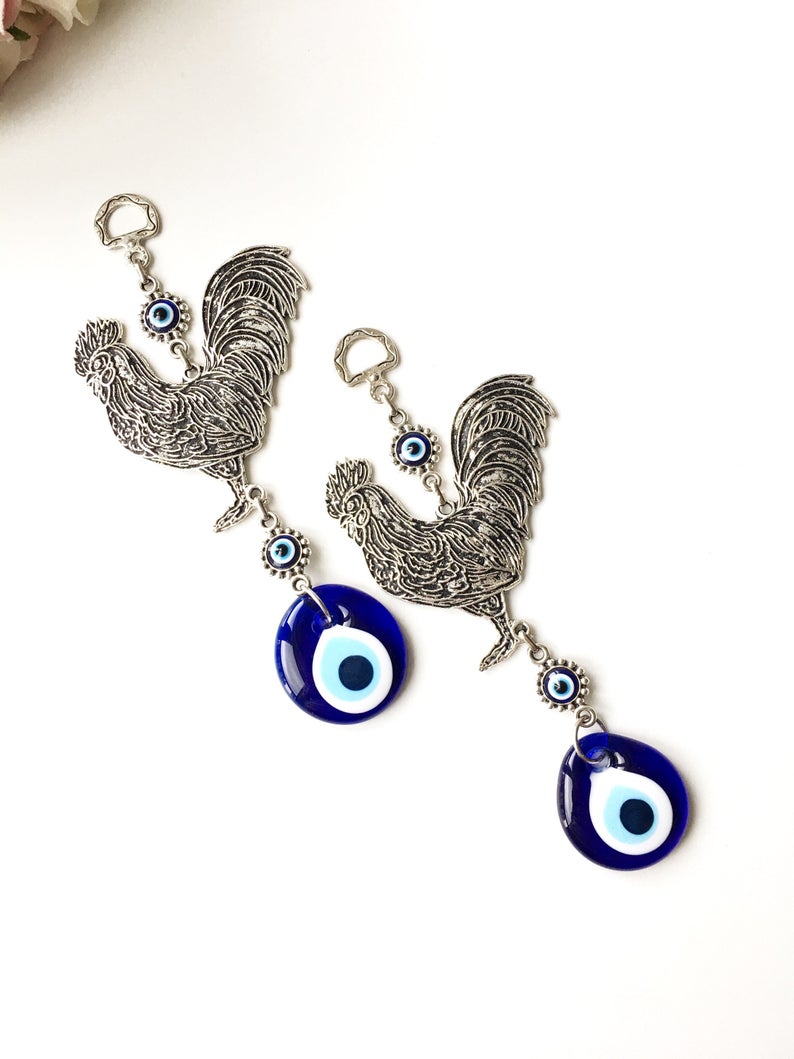 Handmade Cock Evil Eye Wall Hanging featuring a vibrant evil eye bead and metal charm, measuring 20cm in length.