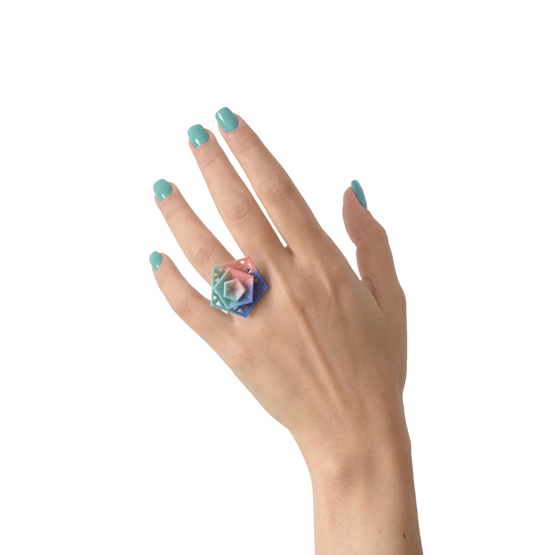 Cocktail Ring Perforated - Vertigo featuring geometric triangular cutouts in vibrant colors, made from lightweight nylon.