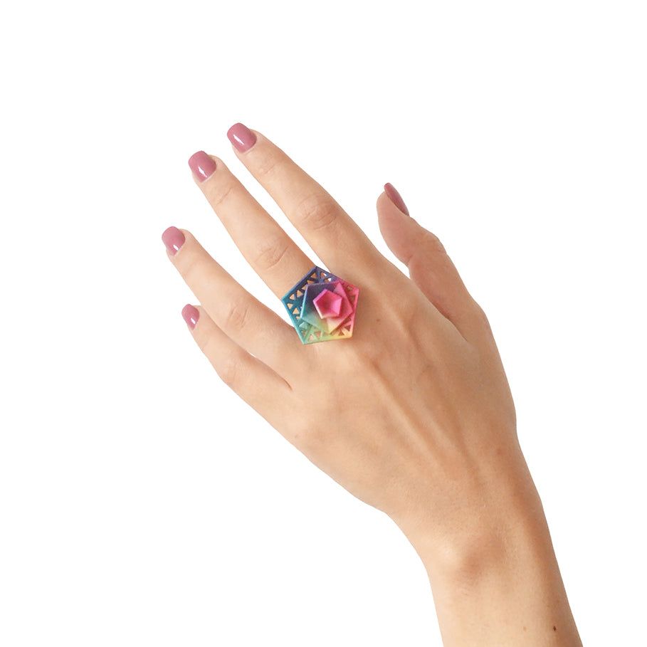 Cocktail Ring Perforated - Vertigo featuring geometric triangular cutouts in vibrant colors, made from lightweight nylon.