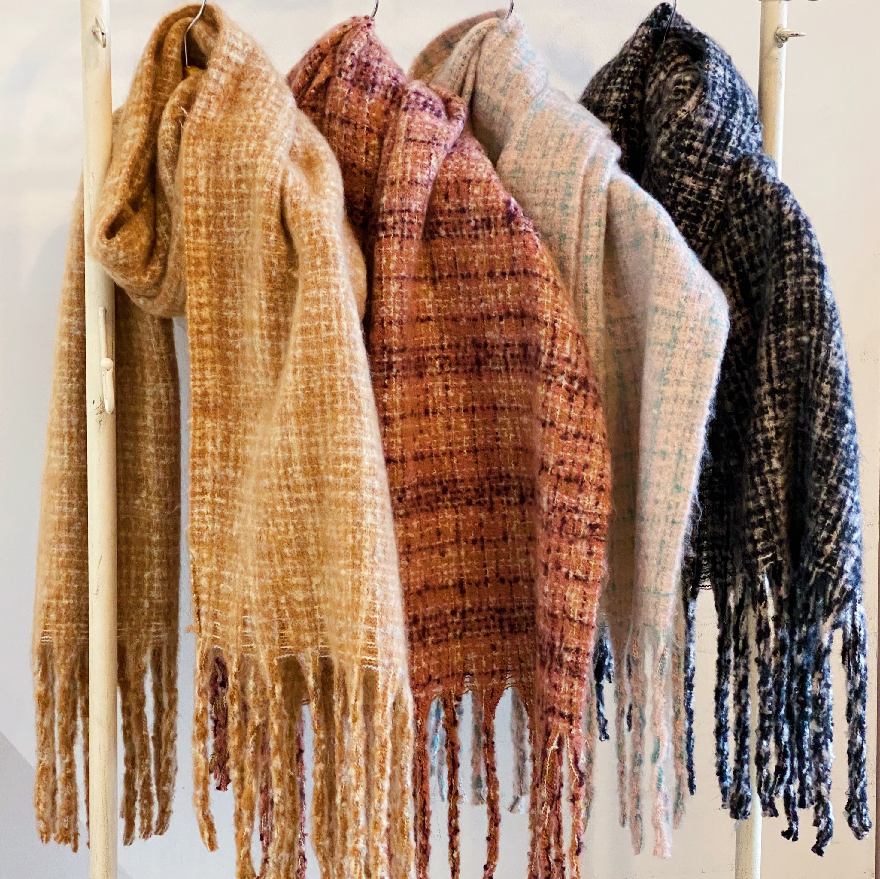 Coco Tweed Fringed Scarf showcasing its chunky texture and stylish fringed edges, perfect for winter wear.