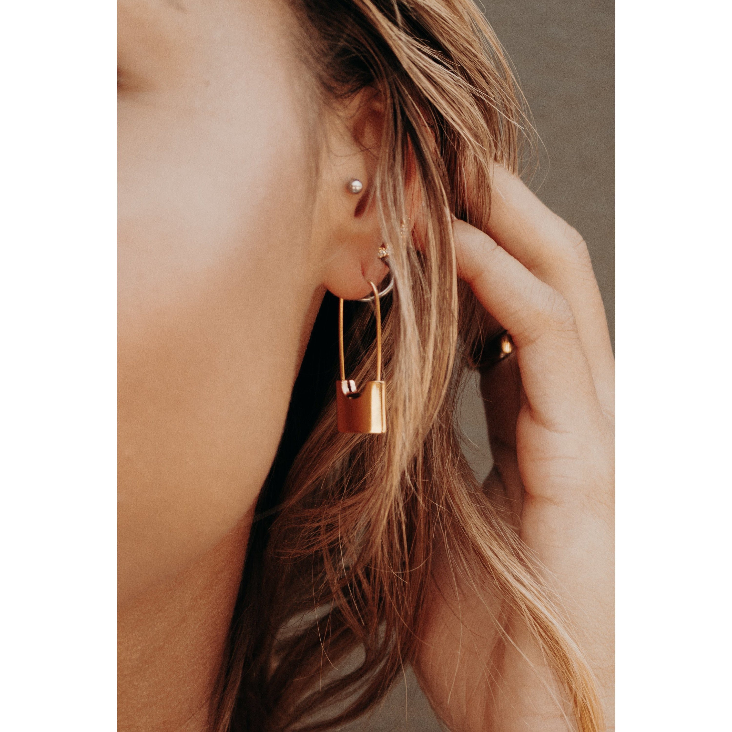 Elegant 18k gold plated lock earrings showcasing a unique design.