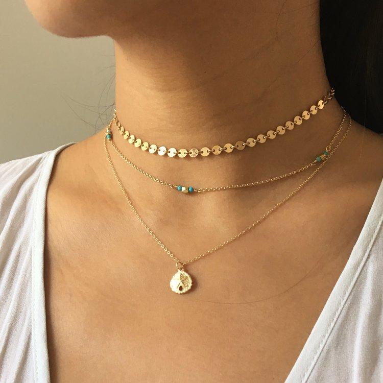 A beautiful Coin Choker featuring a minimalist design with a 4mm pendant, crafted from 14KT gold-filled material, perfect for layering or wearing alone.