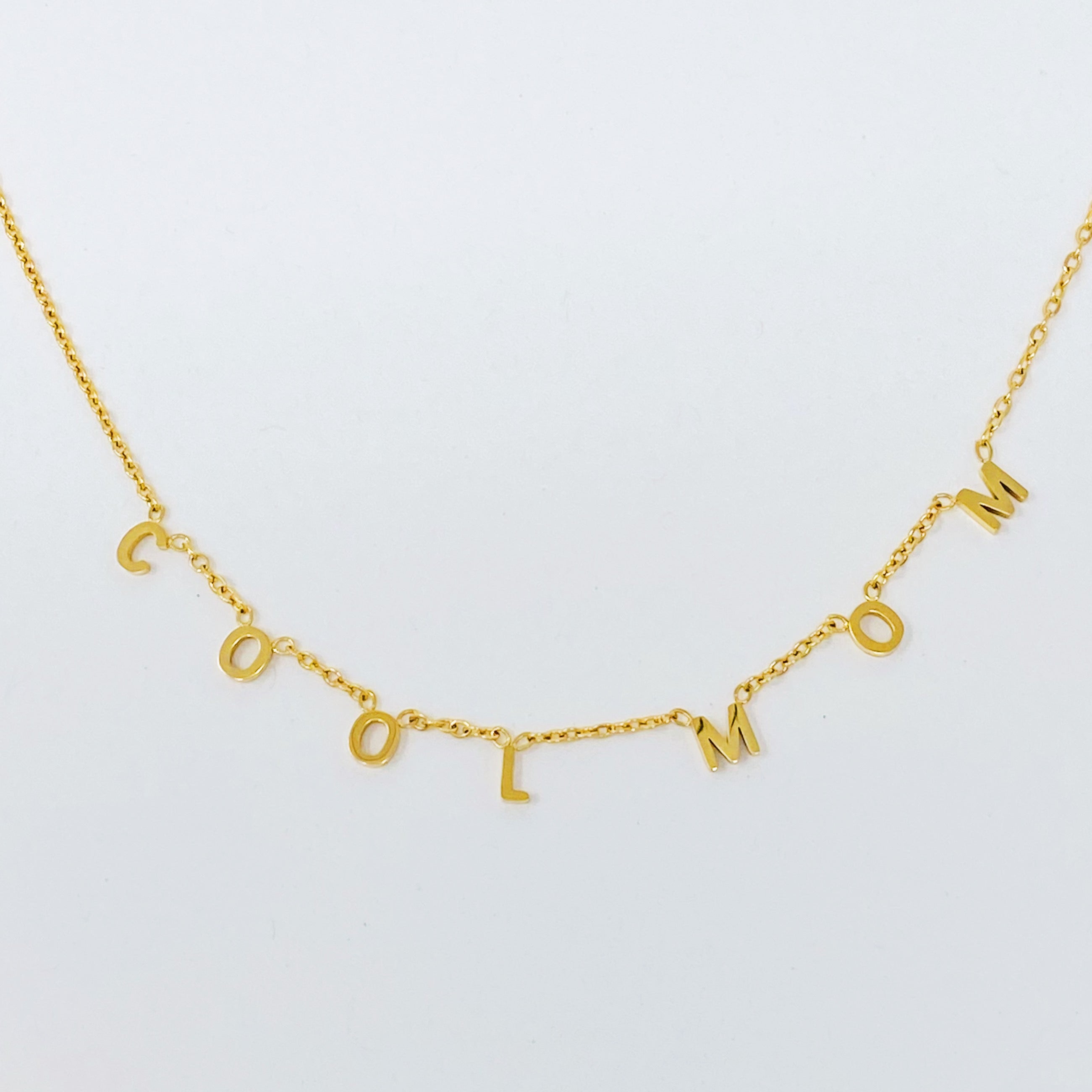 A stylish Cool Mom Necklace featuring high-polished letters on a dainty chain, perfect for fashionable mothers.