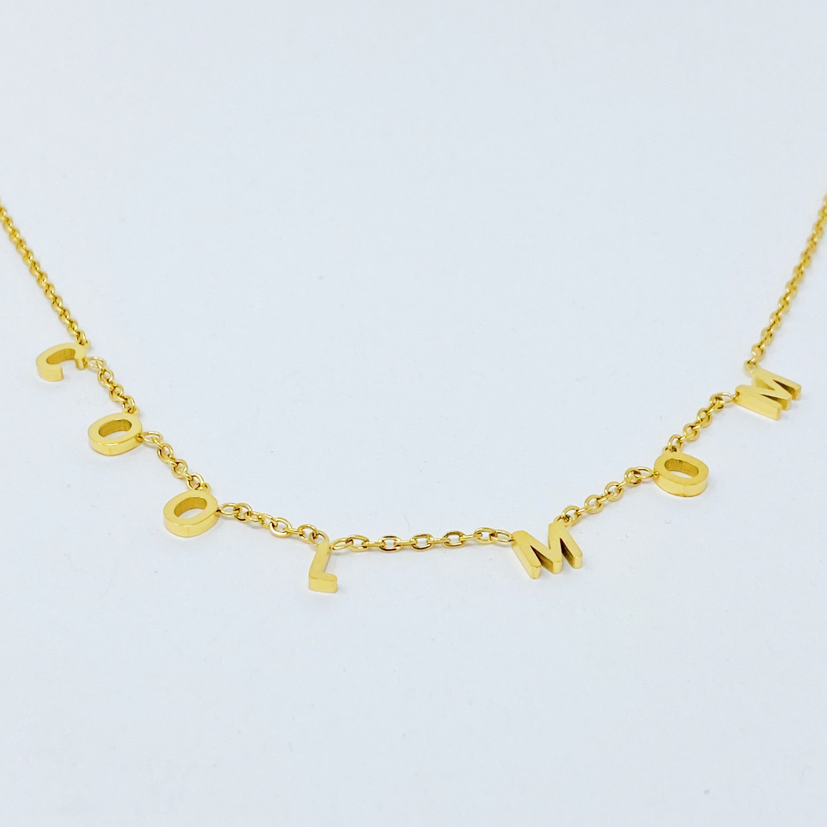 A stylish Cool Mom Necklace featuring high-polished letters on a dainty chain, perfect for fashionable mothers.