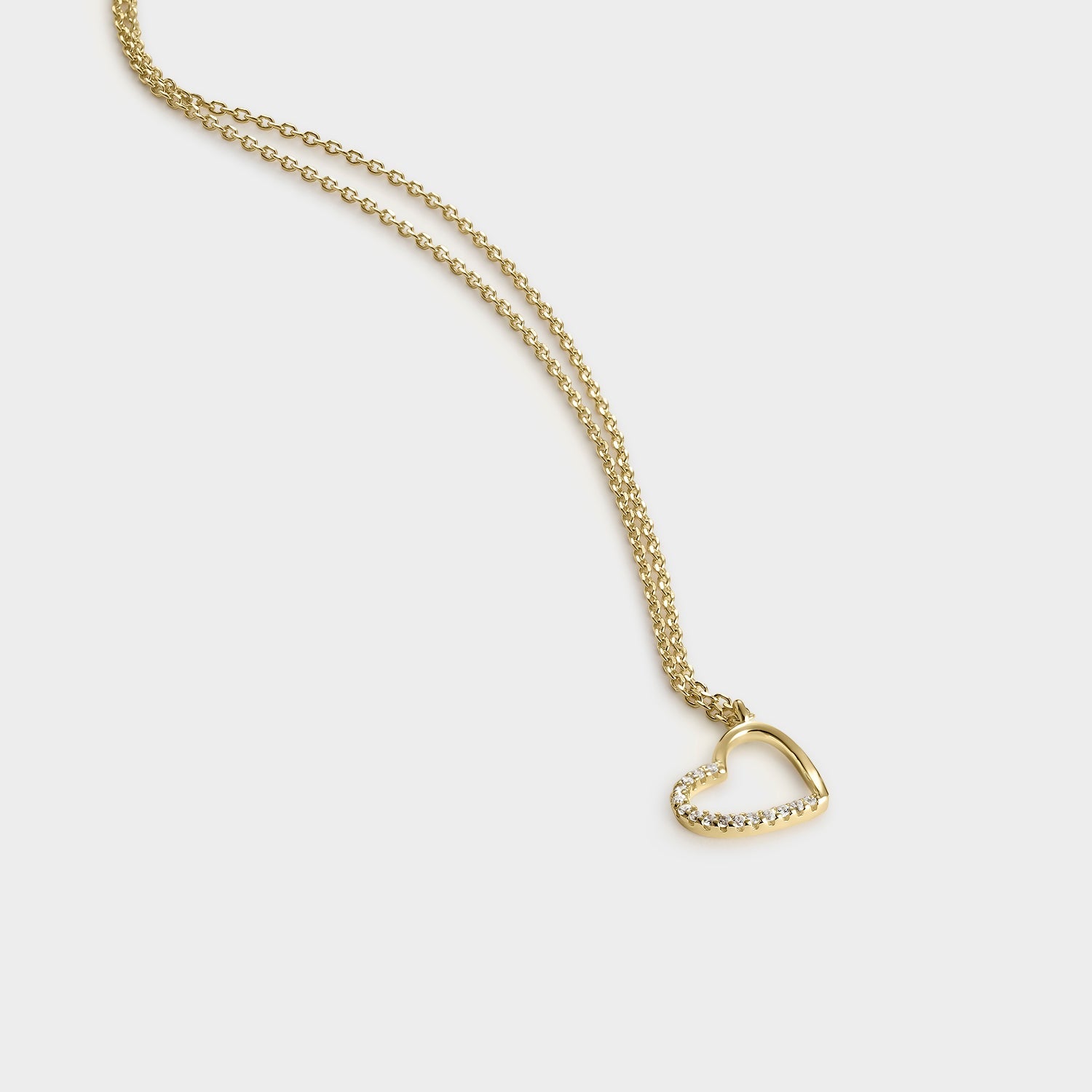 Collar de oro amarillo de 18K con colgante en forma de corazón adornado con circonitas blancas brillantes.