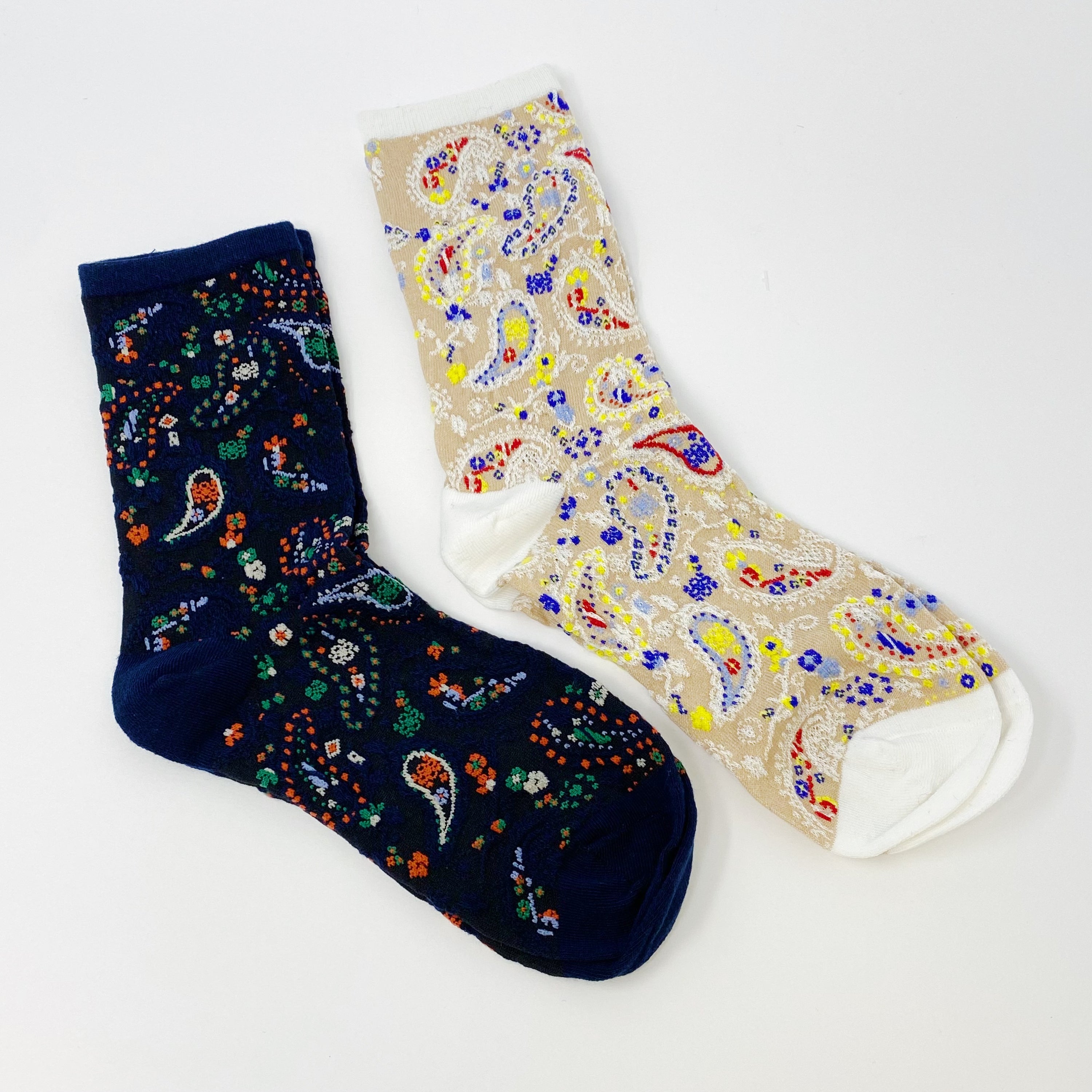 Color Heaven Paisley Socks Set featuring two pairs of stylish socks with vibrant paisley patterns, packaged in a clear cello bag.