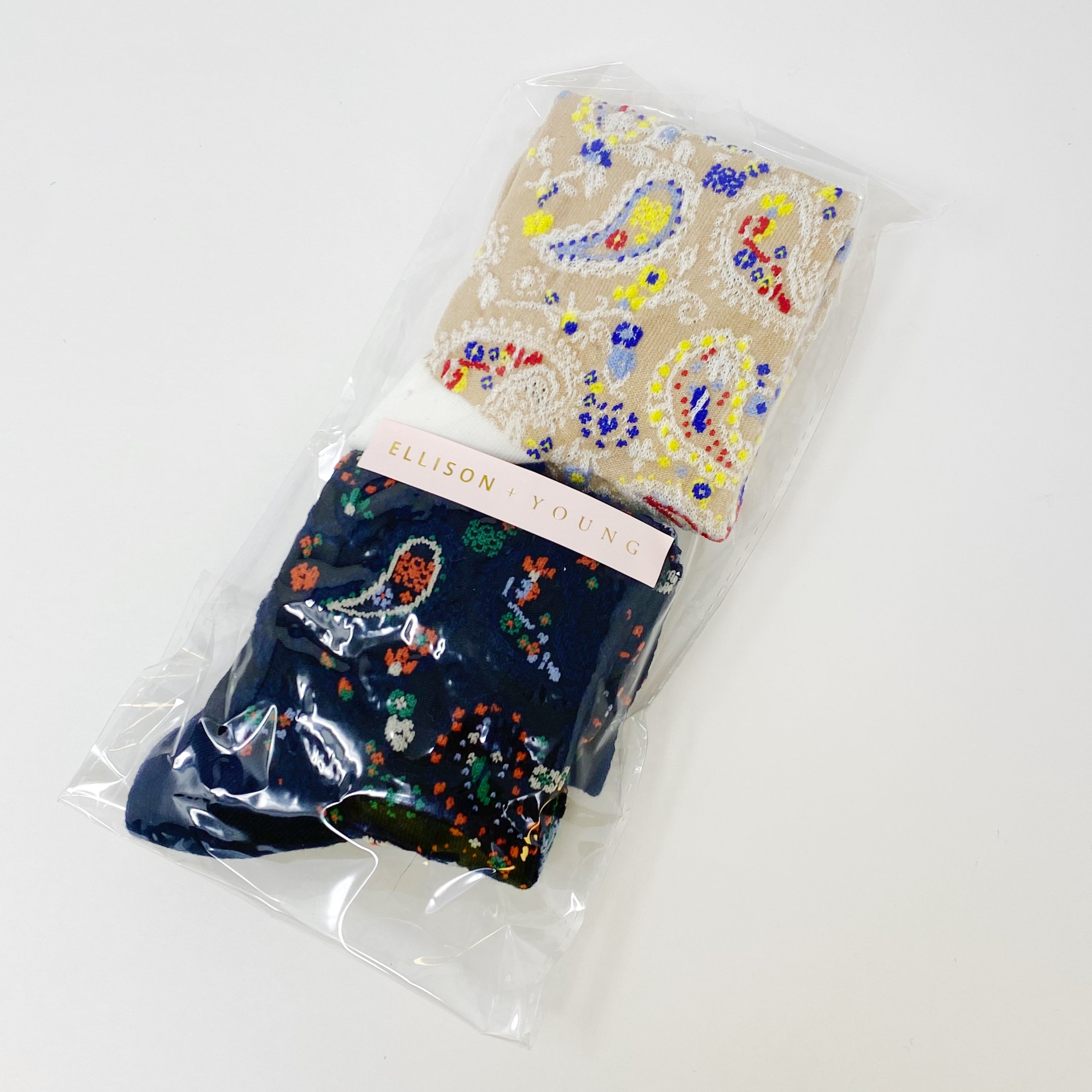 Color Heaven Paisley Socks Set featuring two pairs of stylish socks with vibrant paisley patterns, packaged in a clear cello bag.