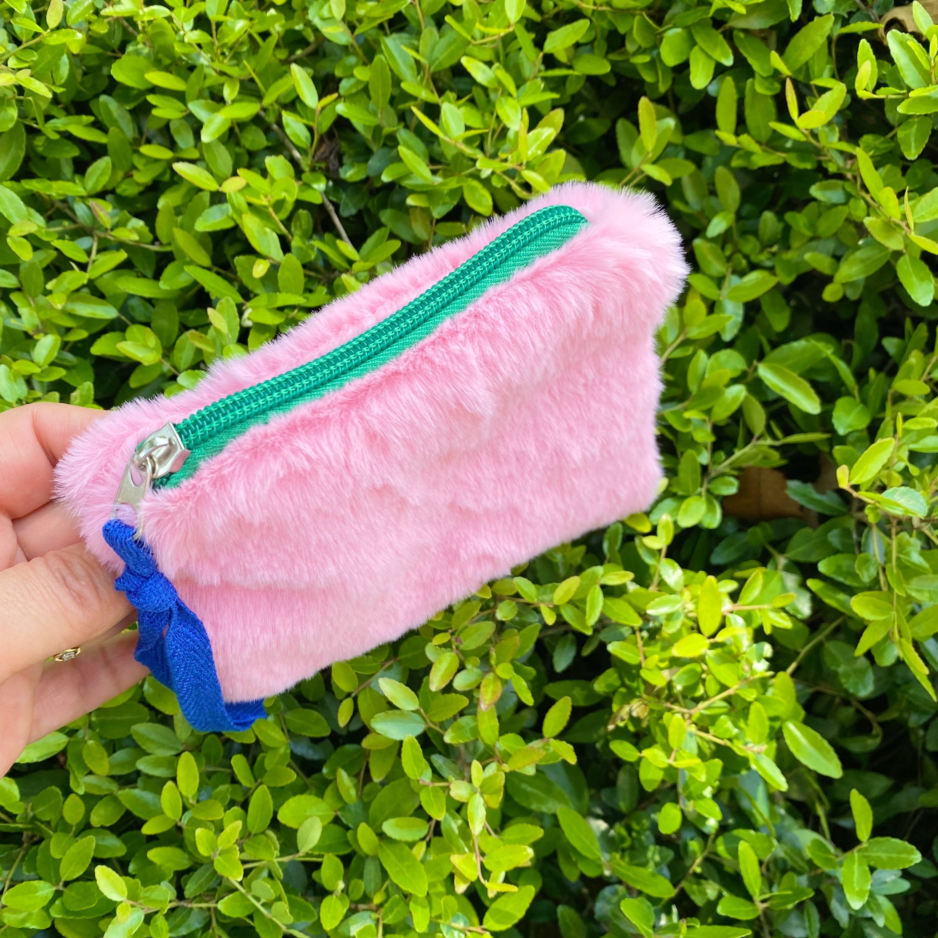 Color Pop Zipped Pouch featuring soft furly fabric and vibrant zipper accent, ideal for storing cards and lipsticks.