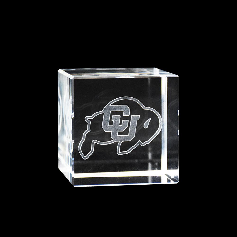 A crystal cube featuring the Colorado Buffaloes logo, showcasing sharp angles and a pristine finish.