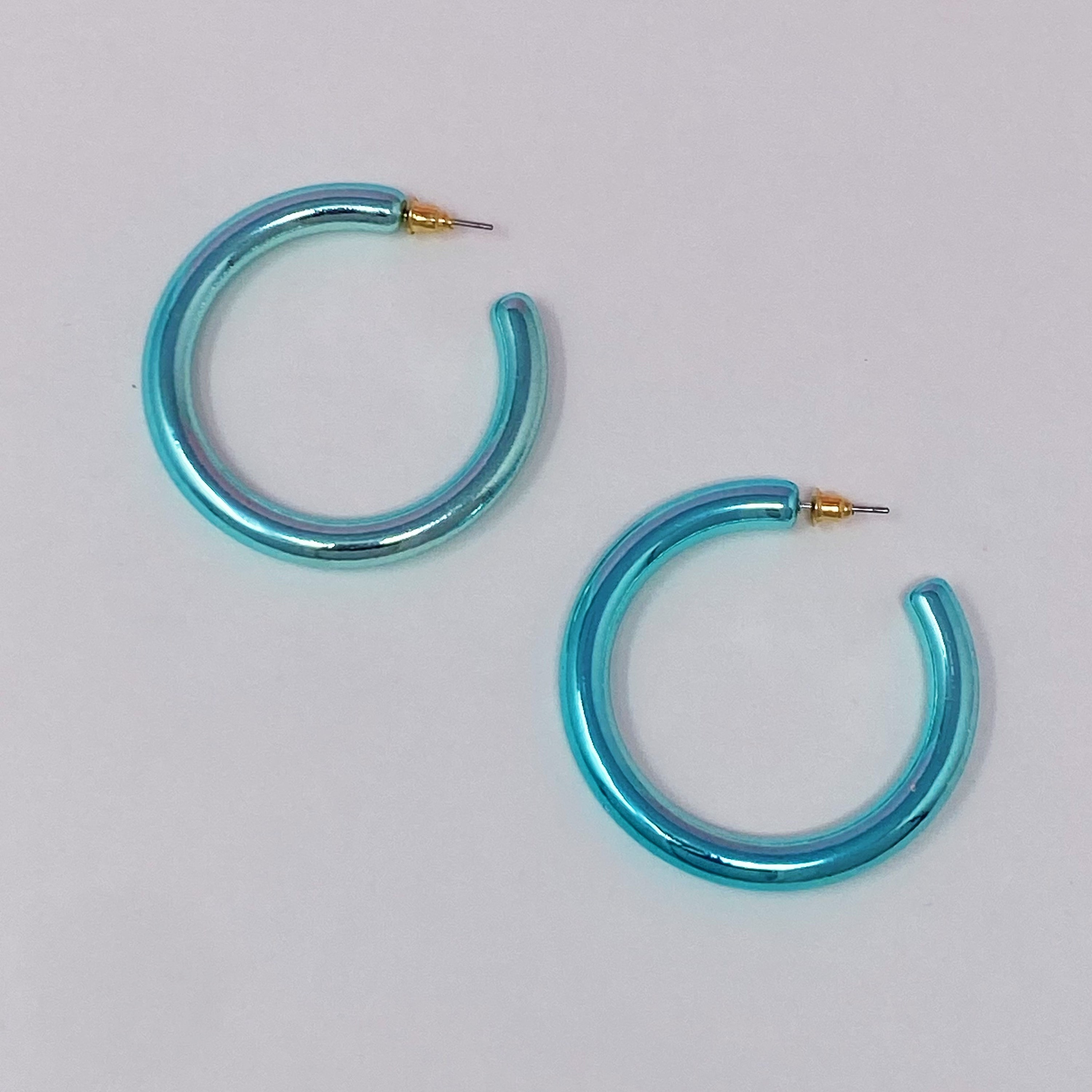 A pair of colorful metallic finish tube hoop earrings, showcasing vibrant hues and a lightweight design, perfect for everyday wear.