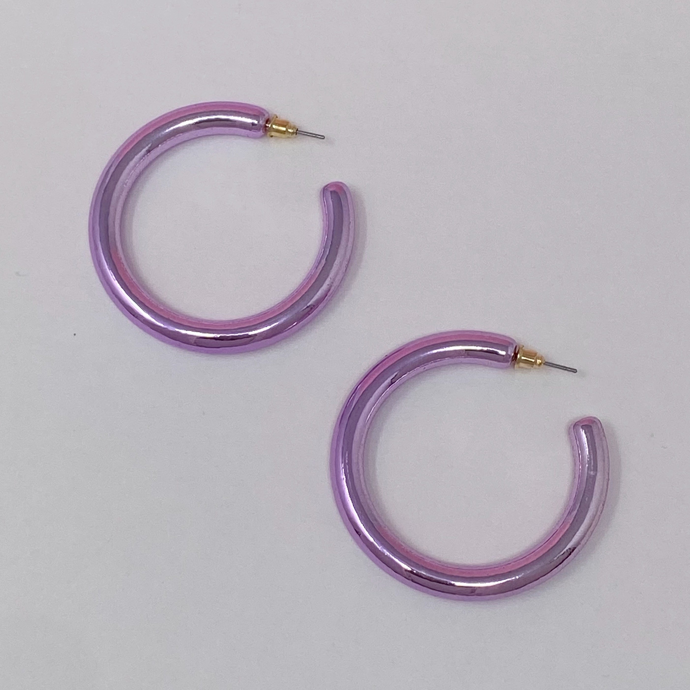 A pair of colorful metallic finish tube hoop earrings, showcasing vibrant hues and a lightweight design, perfect for everyday wear.