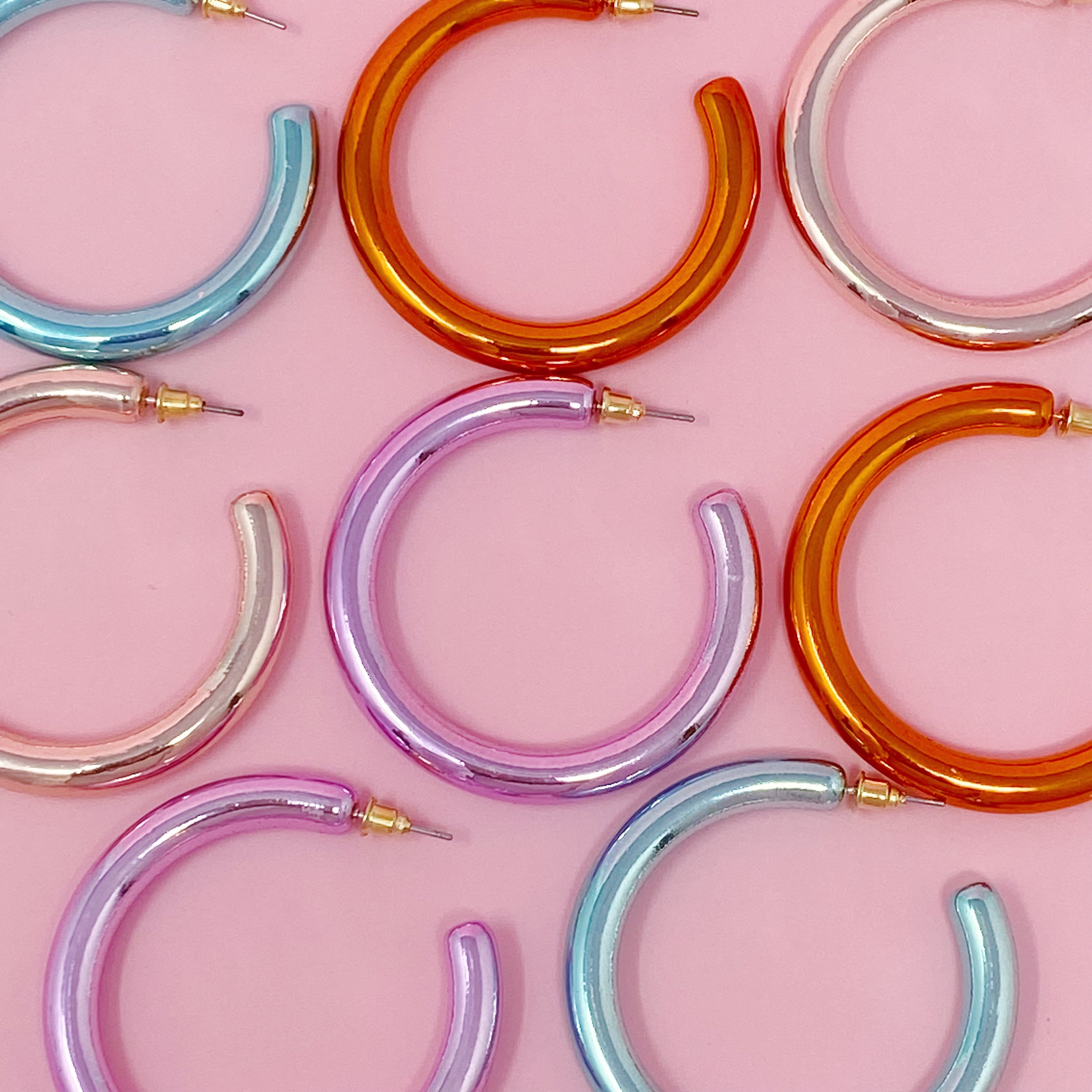 A pair of colorful metallic finish tube hoop earrings, showcasing vibrant hues and a lightweight design, perfect for everyday wear.