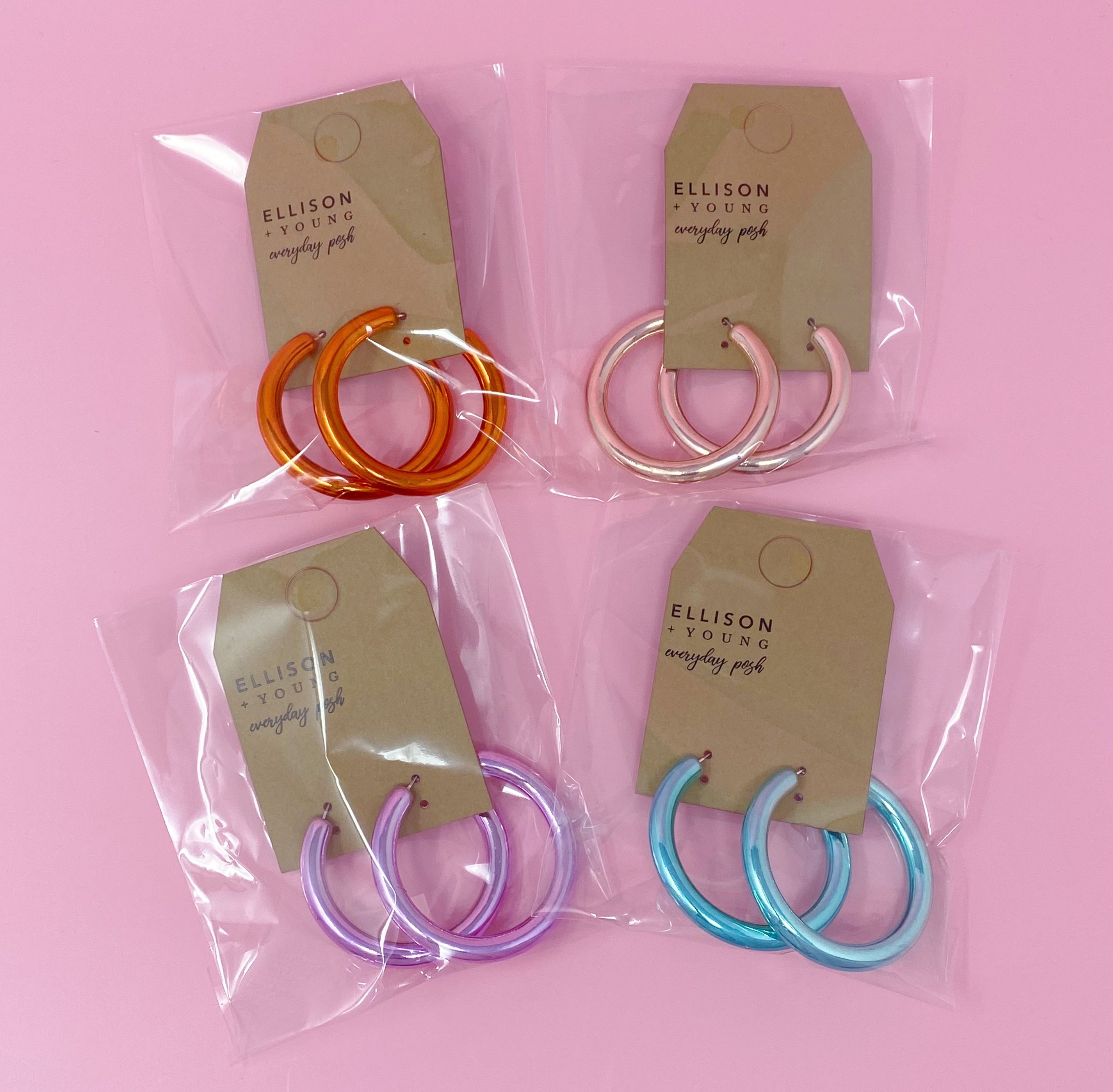 A pair of colorful metallic finish tube hoop earrings, showcasing vibrant hues and a lightweight design, perfect for everyday wear.