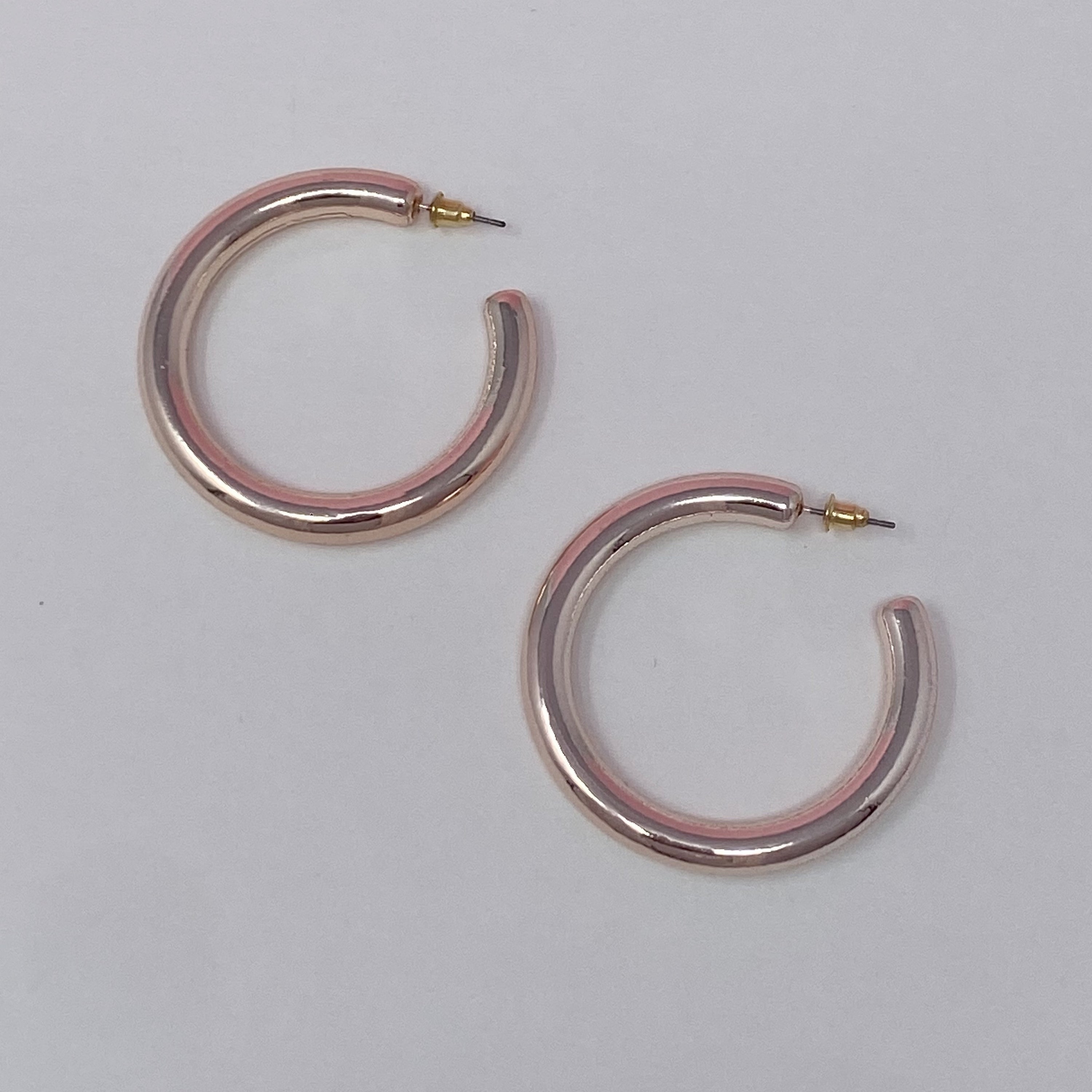 A pair of colorful metallic finish tube hoop earrings, showcasing vibrant hues and a lightweight design, perfect for everyday wear.