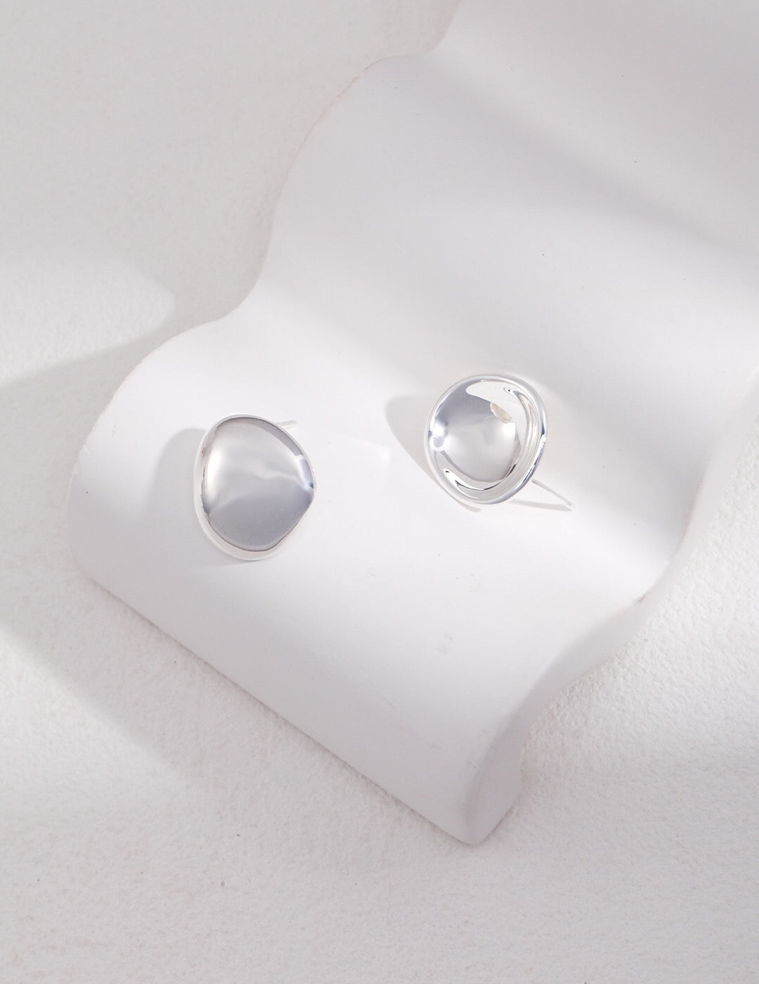 Concave and Convex Style Asymmetrical Stud Earrings in sterling silver with gold vermeil finish, showcasing unique design and elegant craftsmanship.