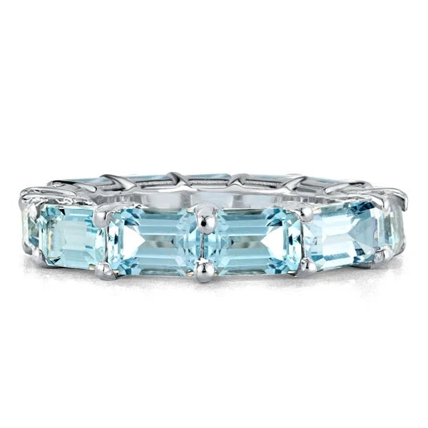 A stunning comfortable wedding band made of 925 sterling silver with a real white gold surface and a created aquamarine stone, showcasing elegance and durability.