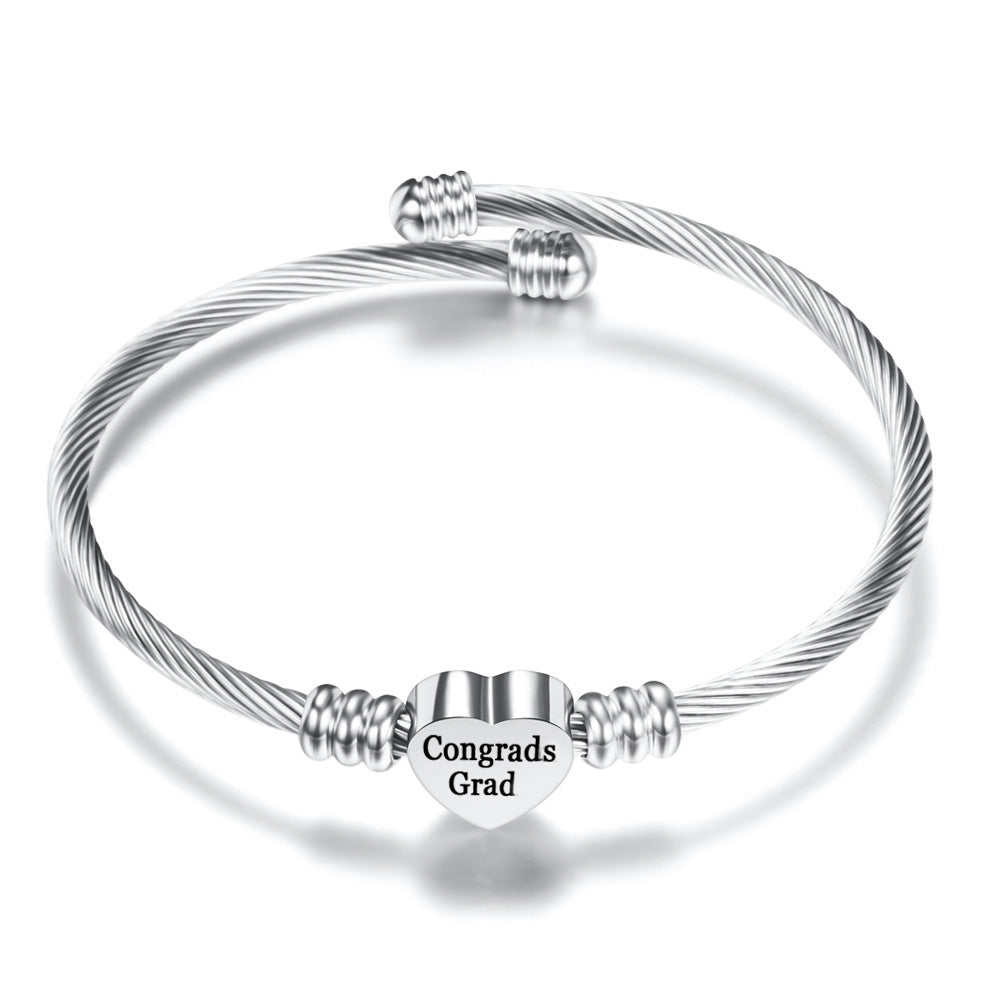 Silver stainless steel heart charm bangle for graduation gifts, adjustable and lead-free.