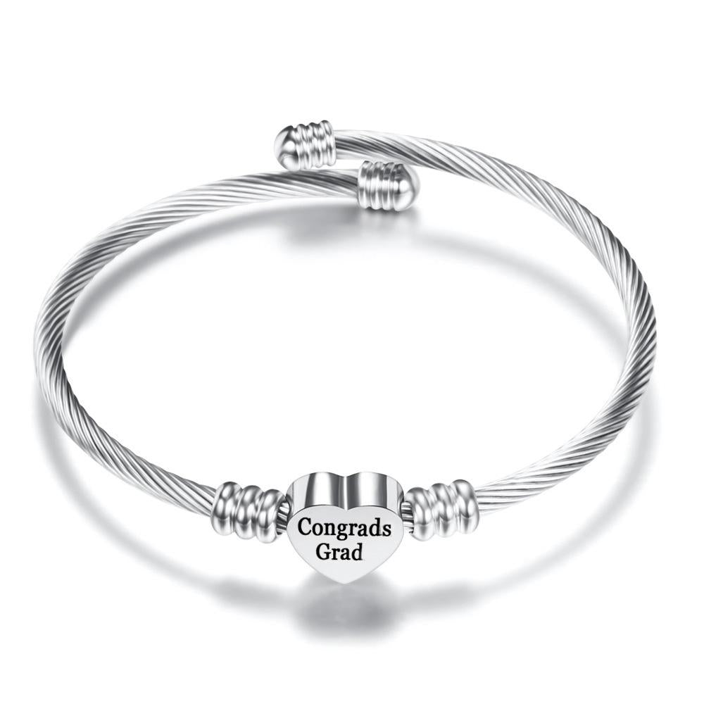 A silver stainless steel bangle featuring a heart charm with 'Congrads Grad' engraving, perfect for 2020 graduates.