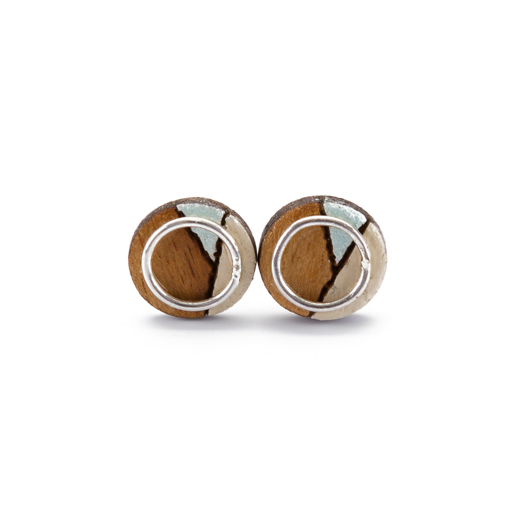 Conture Eco Luxury Wood Stud Earrings in four colors, handcrafted from recycled wood with sterling silver backing, showcasing unique natural patterns.