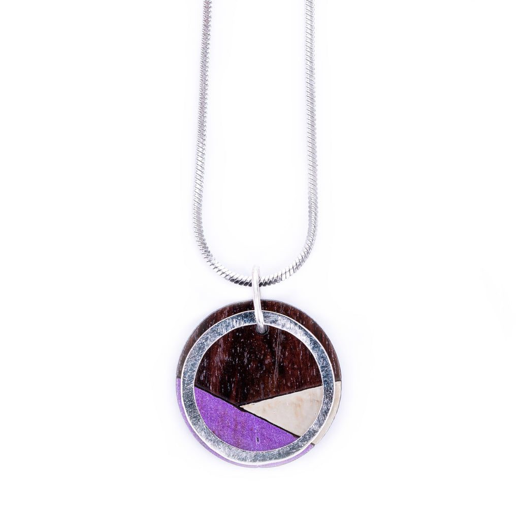 Conture Recycled Wood Silver Necklace showcasing vibrant colors and unique handcrafted design, featuring a silver titanium chain and brass ring.